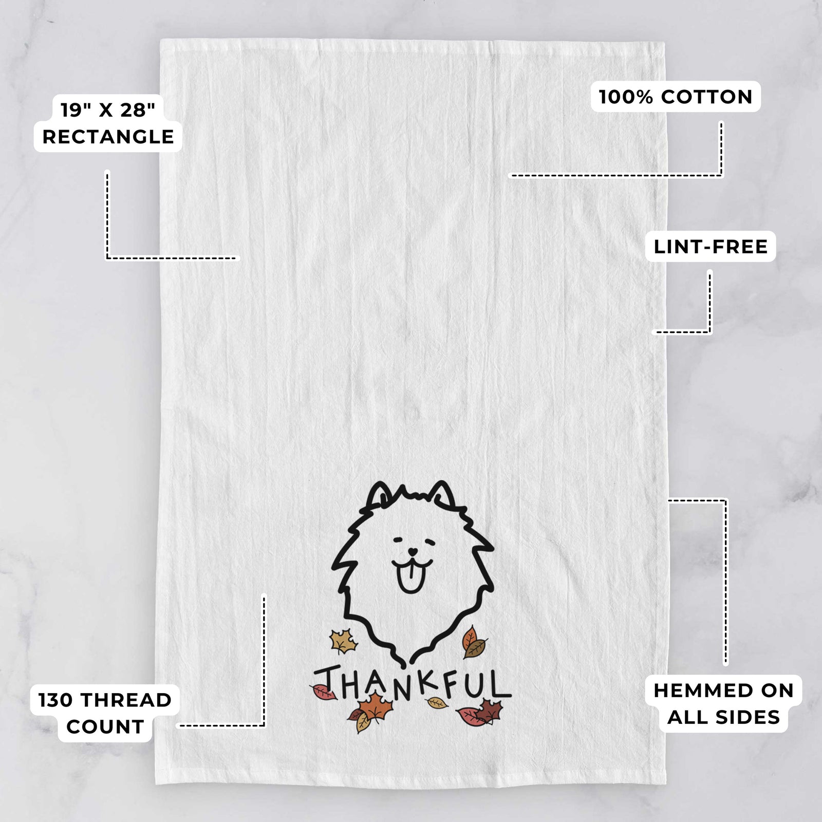 Minimalist line drawing of a Pomeranian with 'Thankful' lettering on a tea towel, with feature callouts: 19 x 28 inch rectangle, 100% cotton, lint-free, 120 thread count, hemmed on all sides