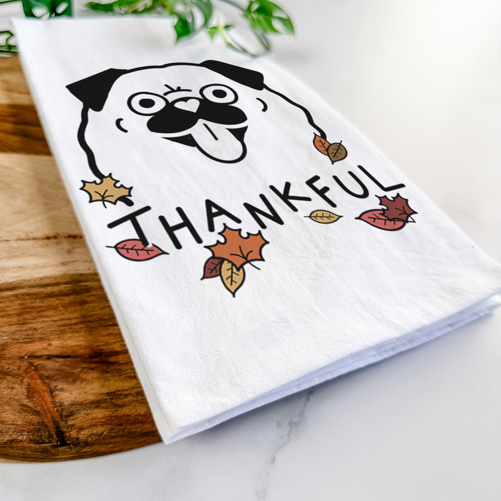 Minimalist line drawing of a Pug with 'Thankful' lettering on a tea towel