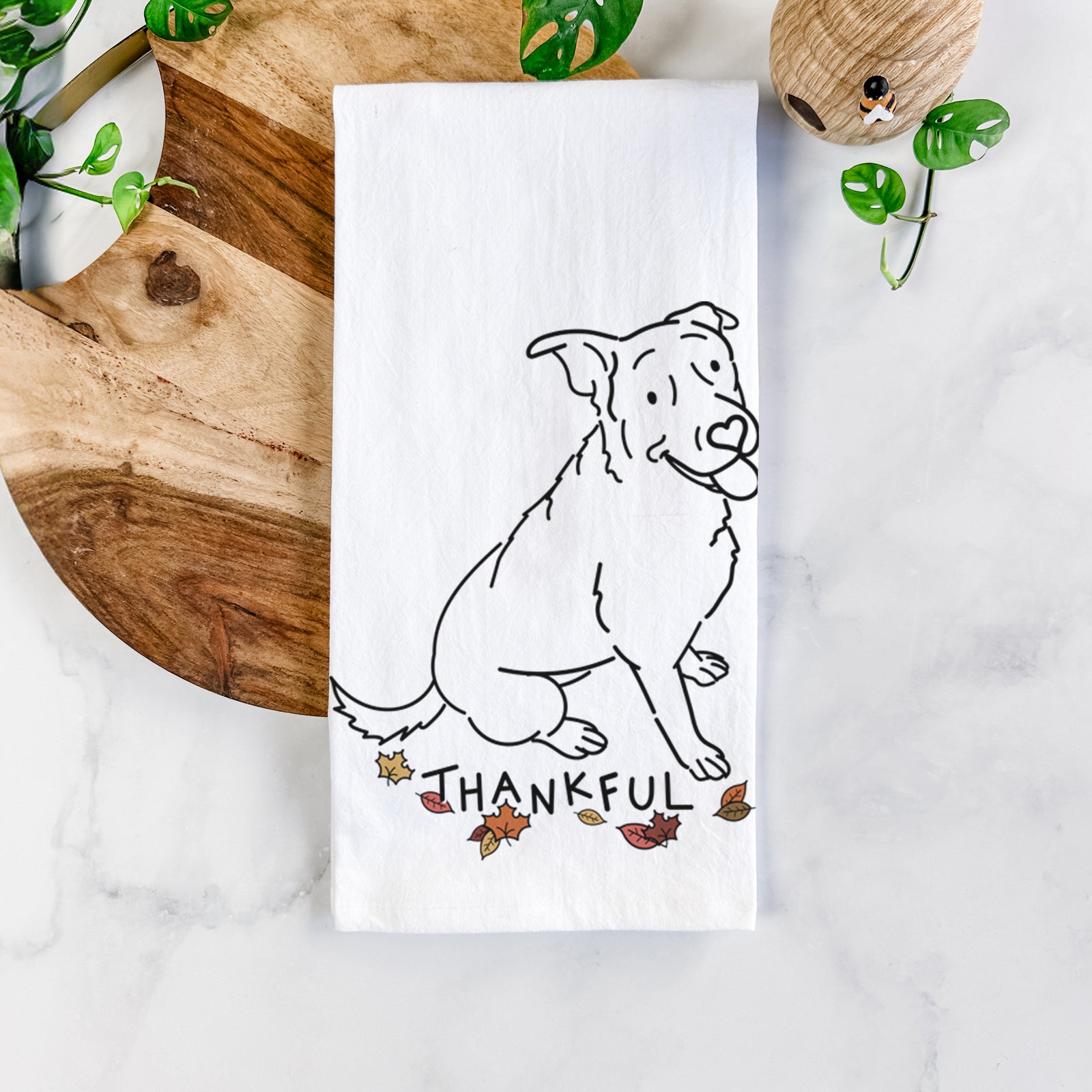 Minimalist line drawing of Rocky the Rottweiler Mix with 'Thankful' lettering on a tea towel