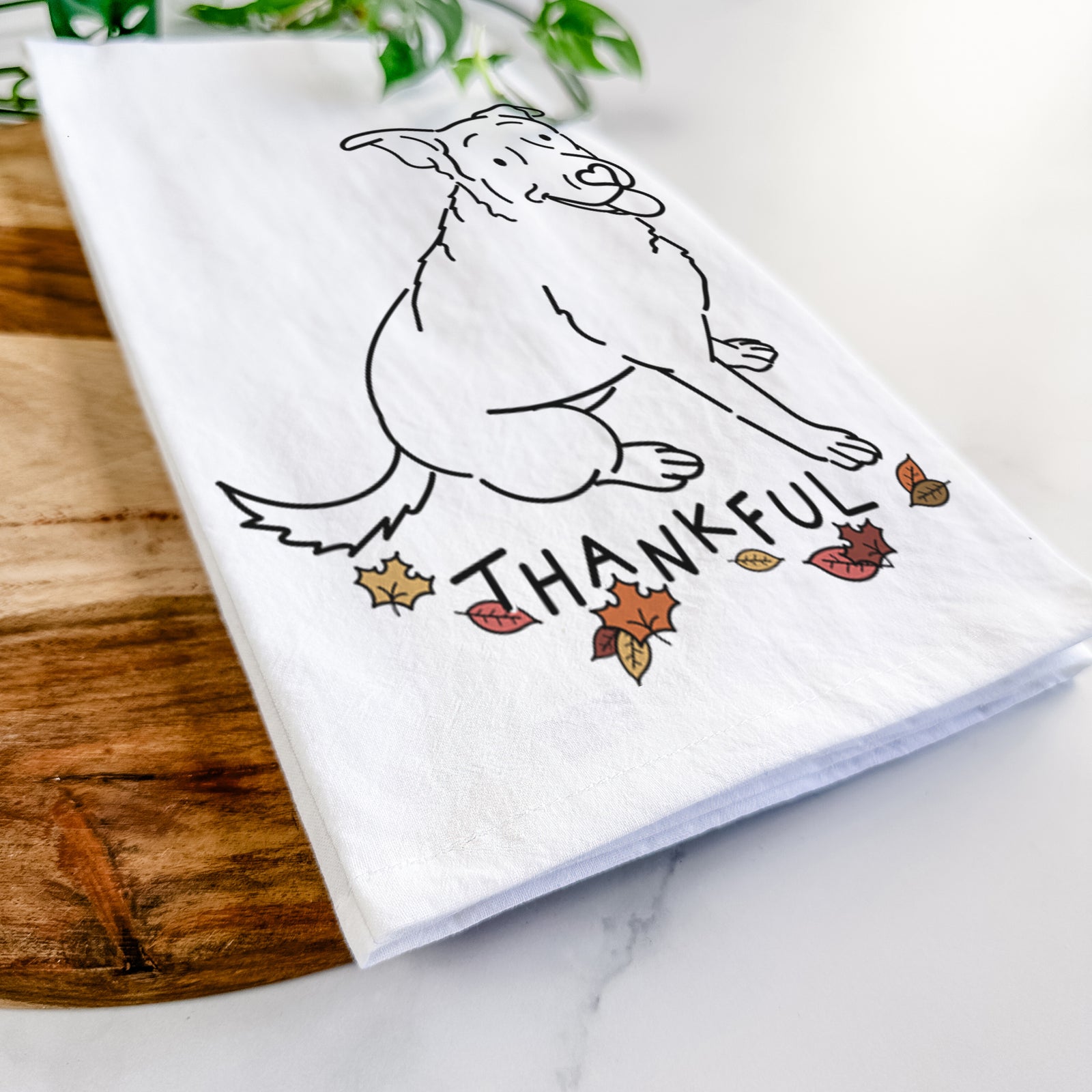 Minimalist line drawing of Rocky the Rottweiler Mix with 'Thankful' lettering on a tea towel