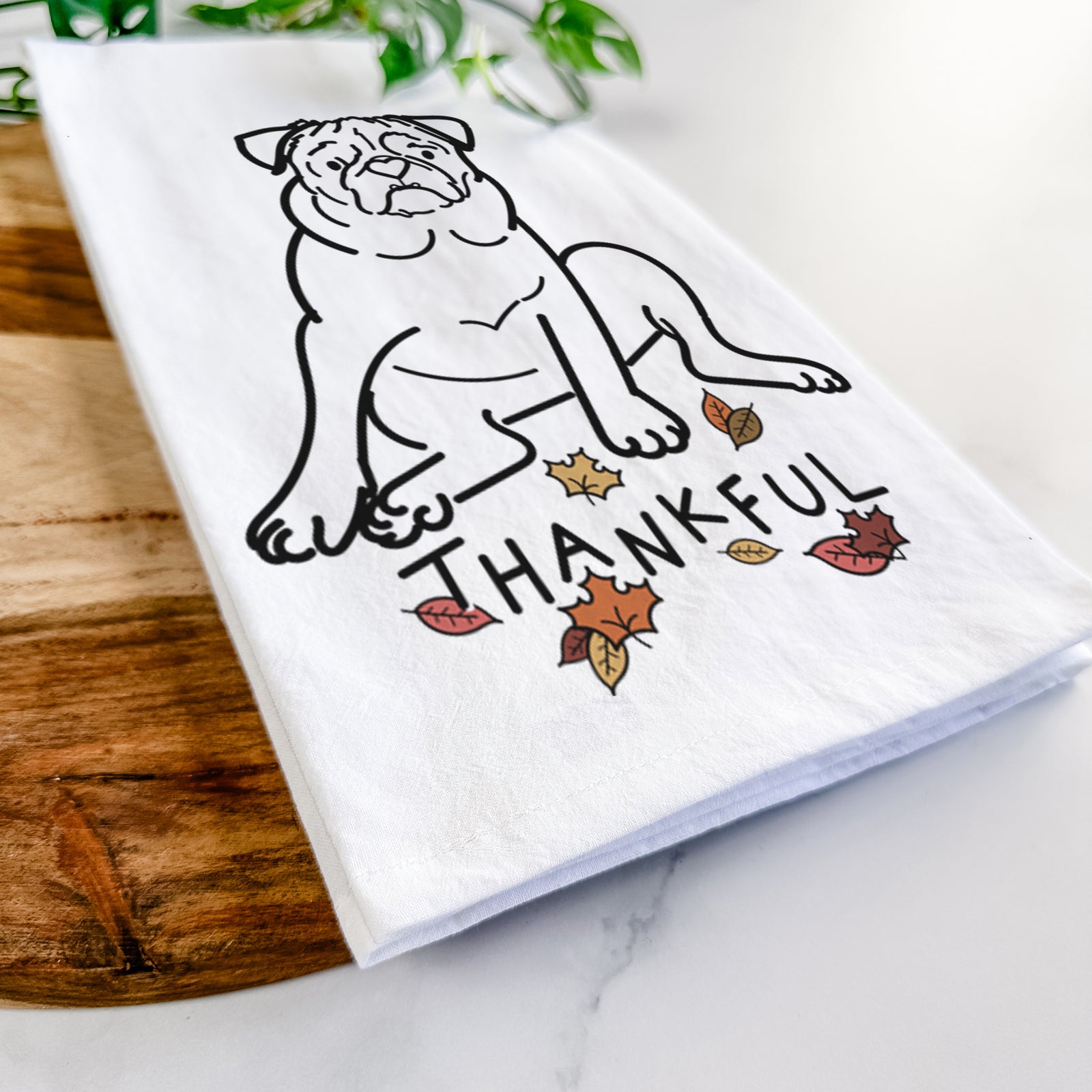 Minimalist line drawing of Rudy the Pug with 'Thankful' lettering on a tea towel