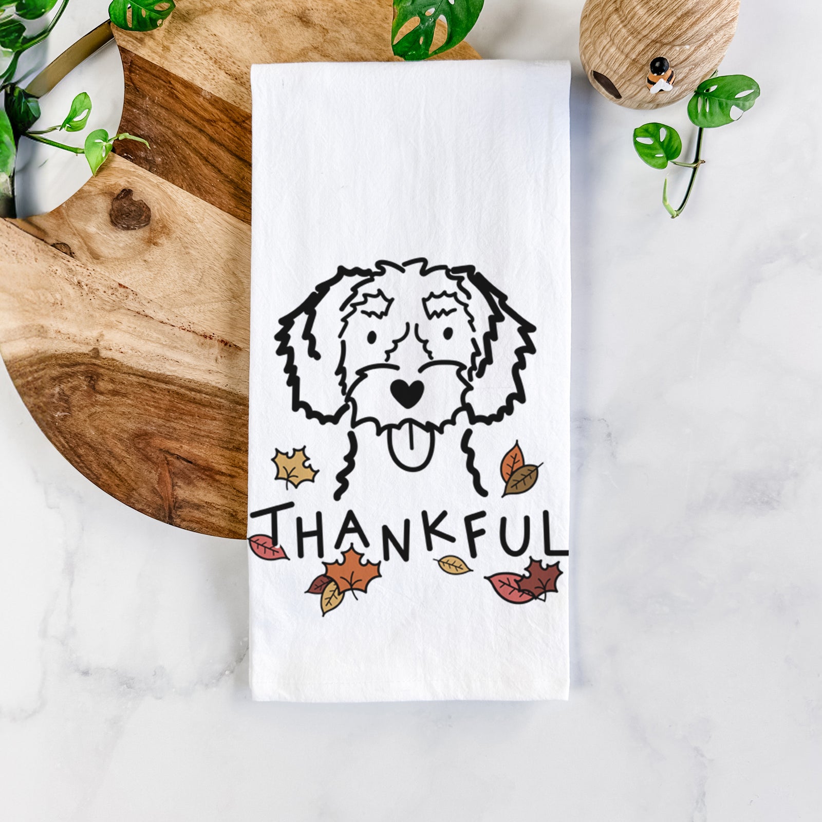 Minimalist line drawing of a White Schnoodle with 'Thankful' lettering on a tea towel