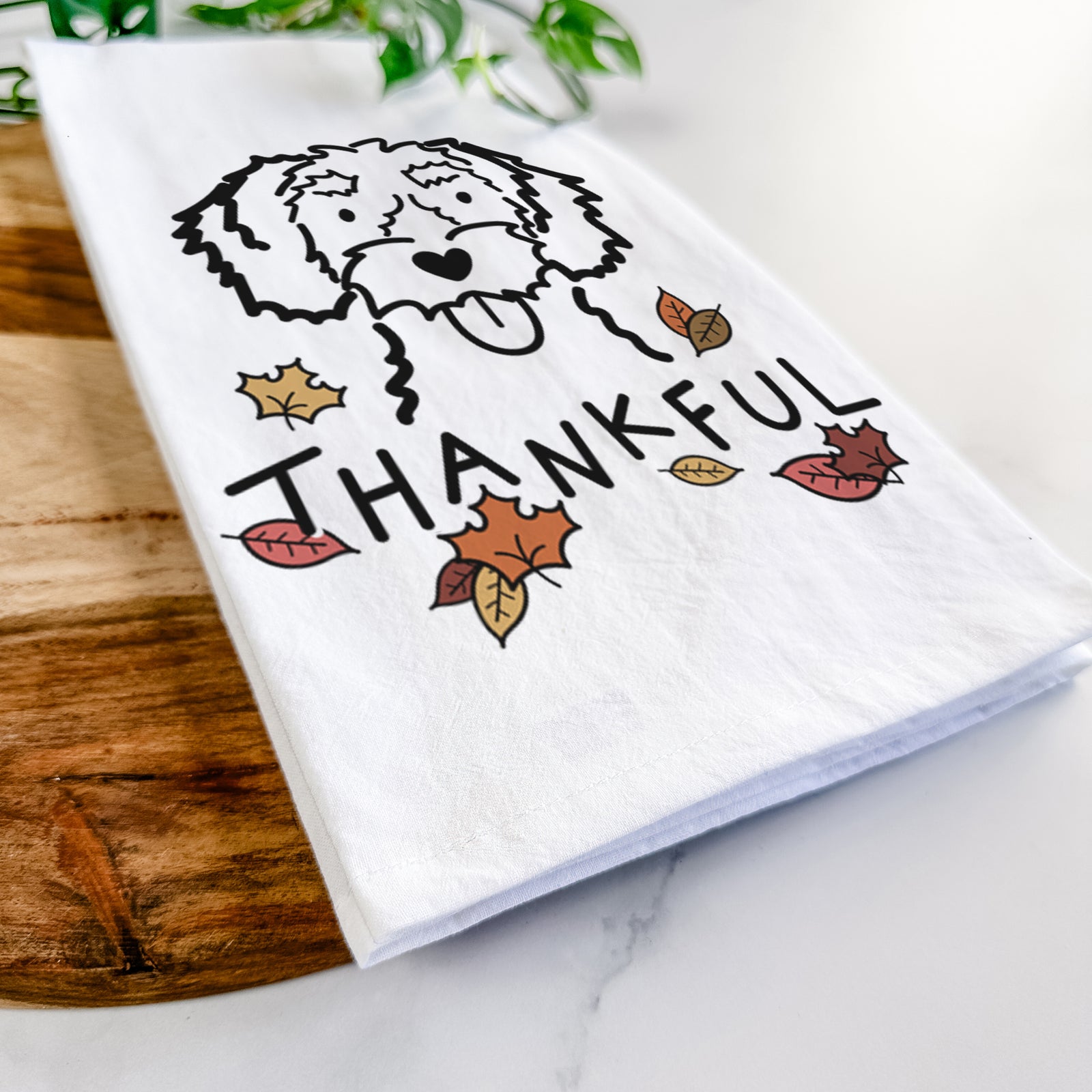 Minimalist line drawing of a White Schnoodle with 'Thankful' lettering on a tea towel