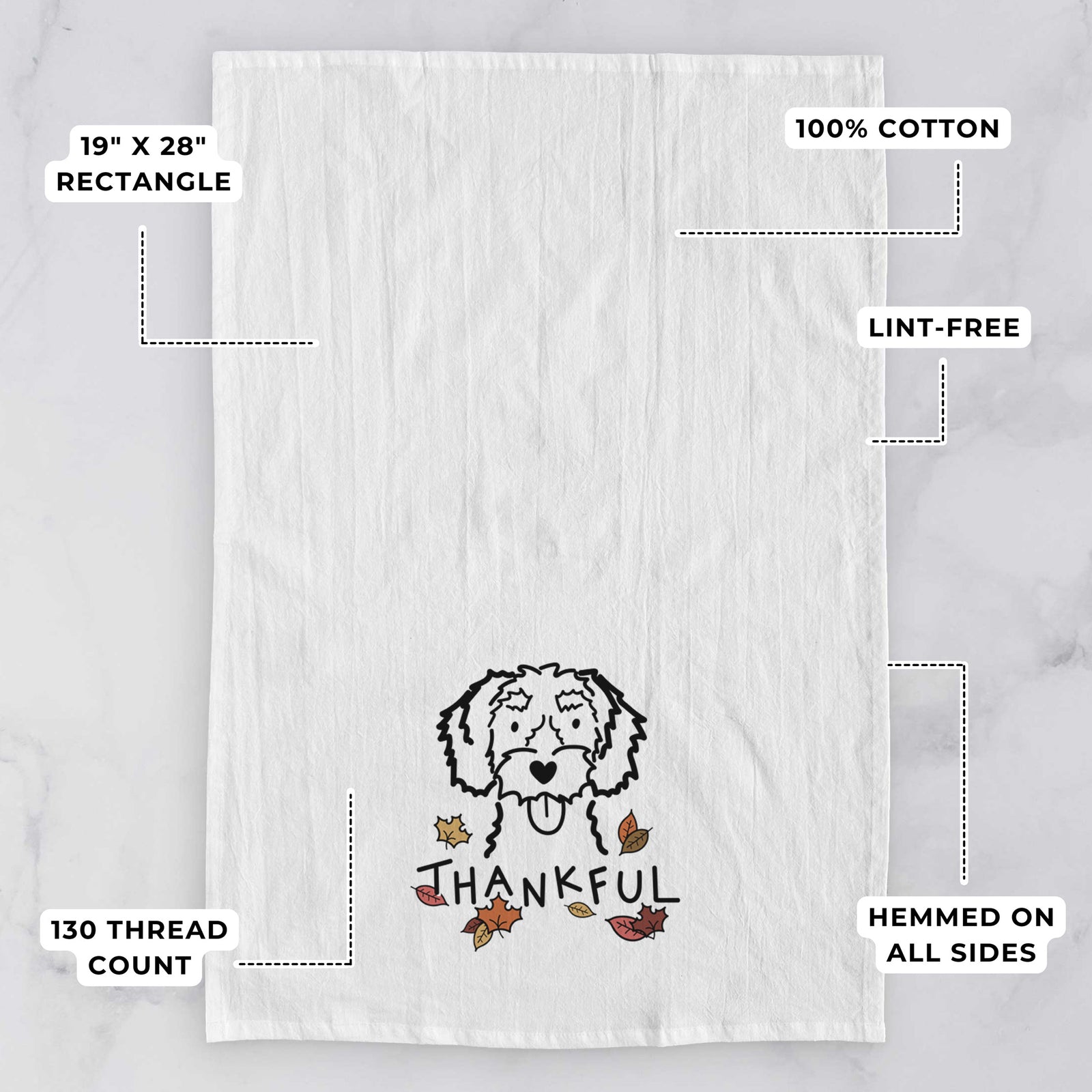 Minimalist line drawing of a White Schnoodle with 'Thankful' lettering on a tea towel, with feature callouts: 19 x 28 inch rectangle, 100% cotton, lint-free, 120 thread count, hemmed on all sides