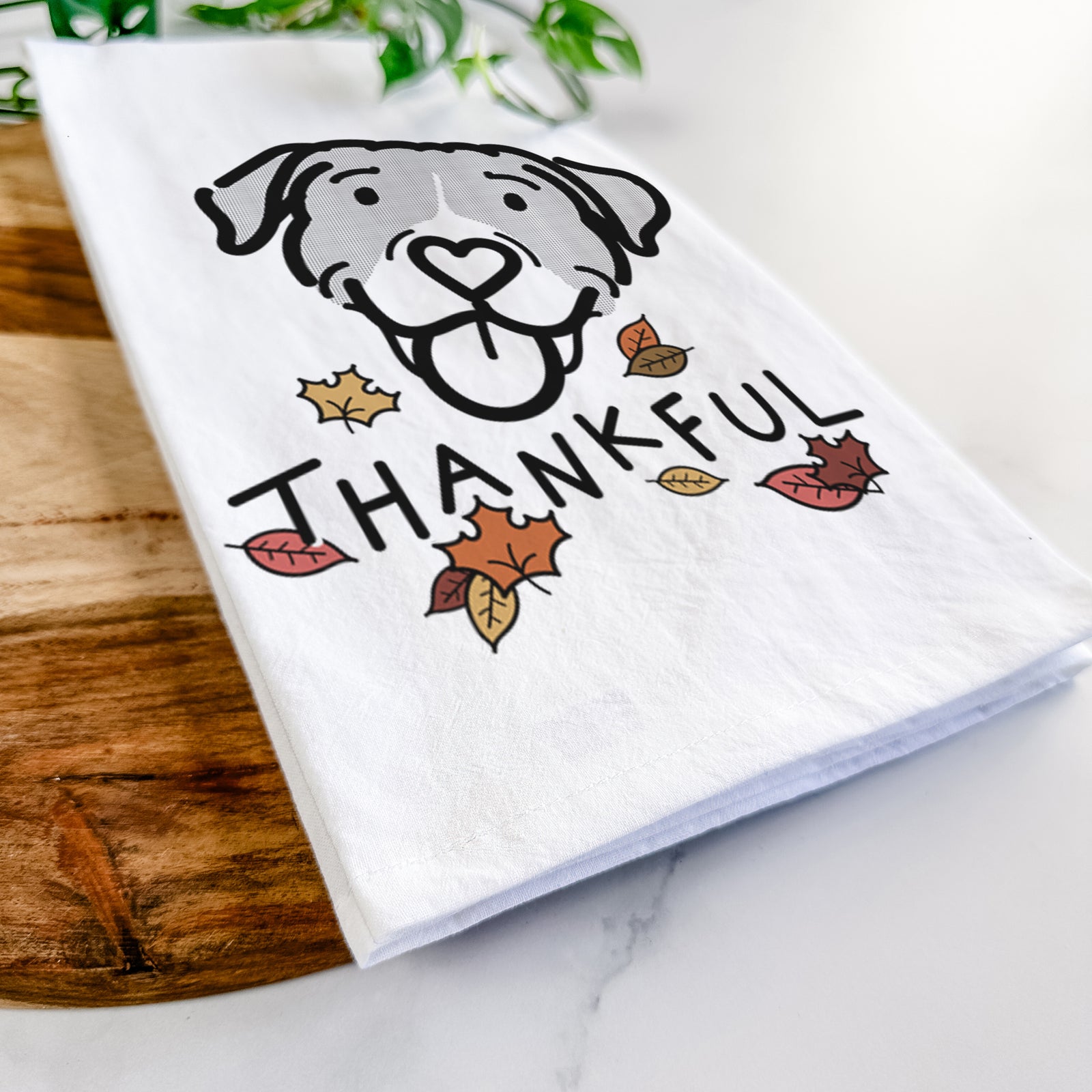 Minimalist line drawing of Shadow the Pitbull Mix with 'Thankful' lettering on a tea towel