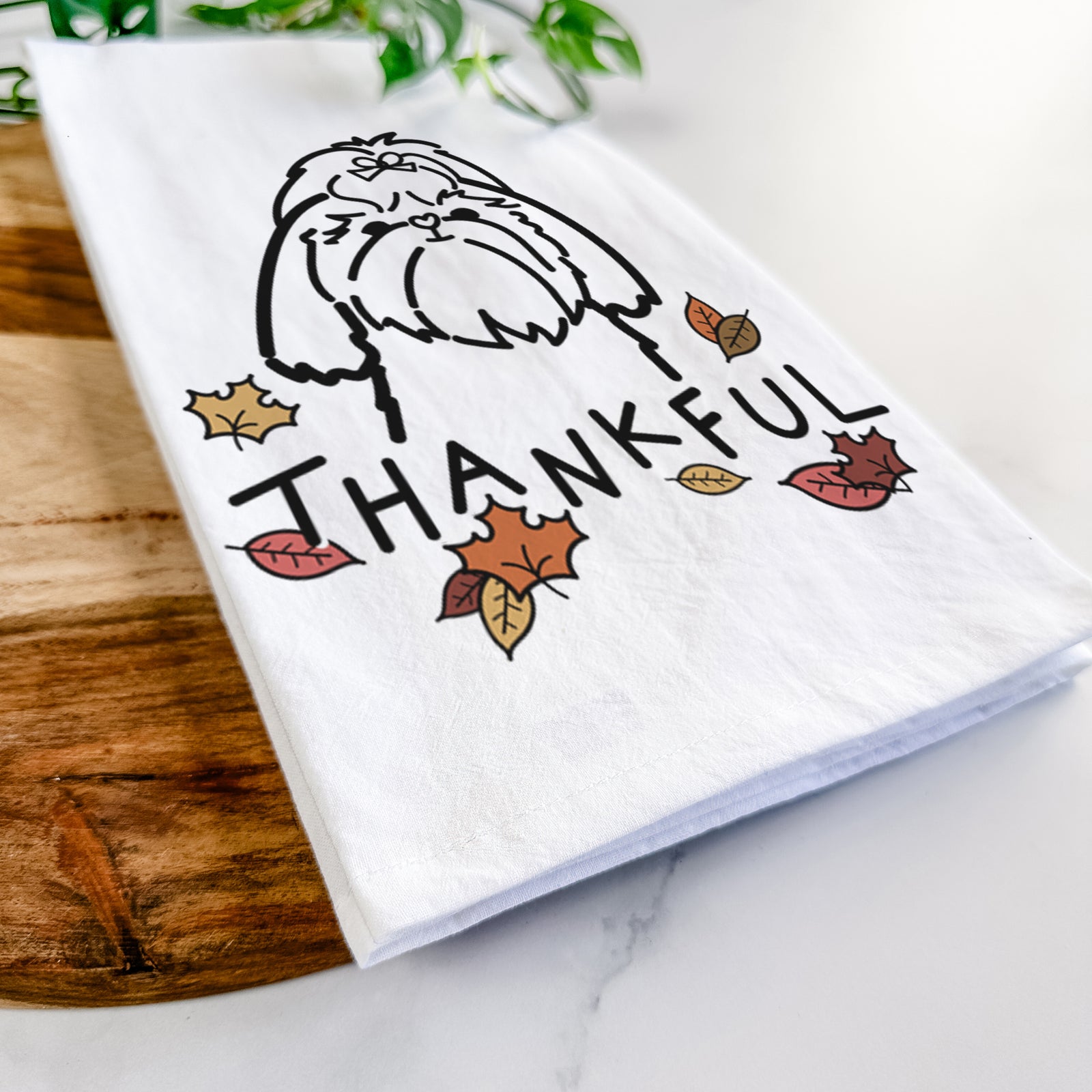 Minimalist line drawing of a Shih Tzu with 'Thankful' lettering on a tea towel