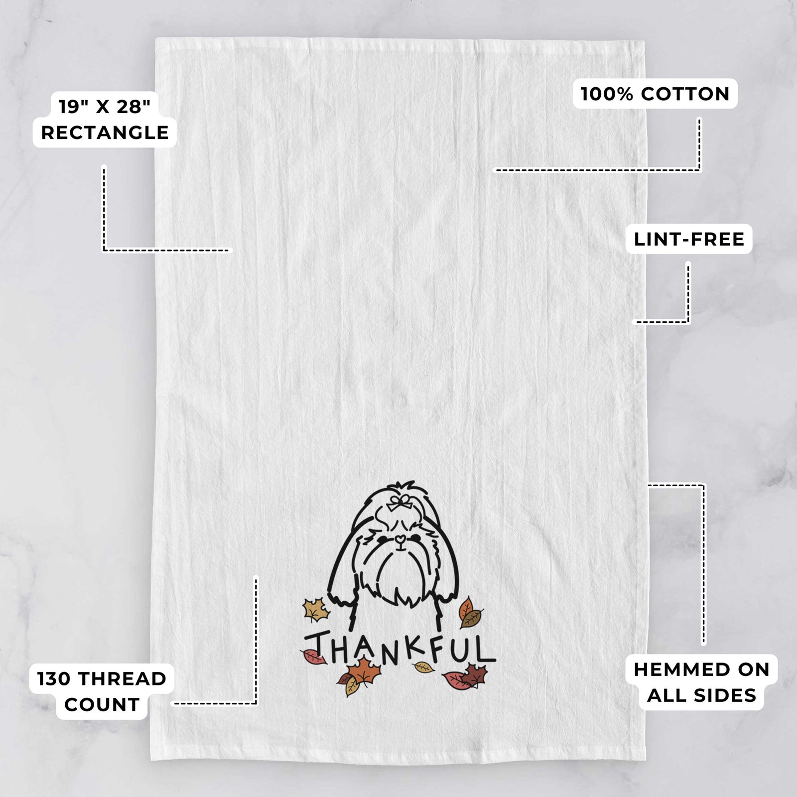 Minimalist line drawing of a Shih Tzu with 'Thankful' lettering on a tea towel, with feature callouts: 19 x 28 inch rectangle, 100% cotton, lint-free, 120 thread count, hemmed on all sides