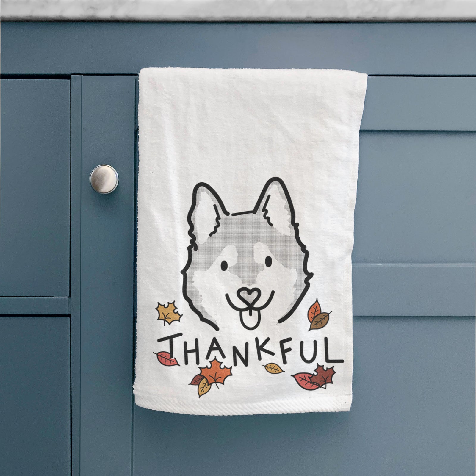Minimalist line drawing of Sitka the Alaskan Klee Kai with 'Thankful' lettering on a decorative hand towel