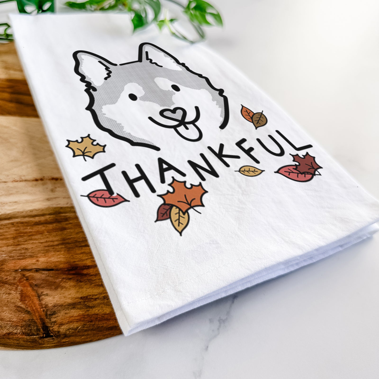 Minimalist line drawing of Sitka the Alaskan Klee Kai with 'Thankful' lettering on a tea towel