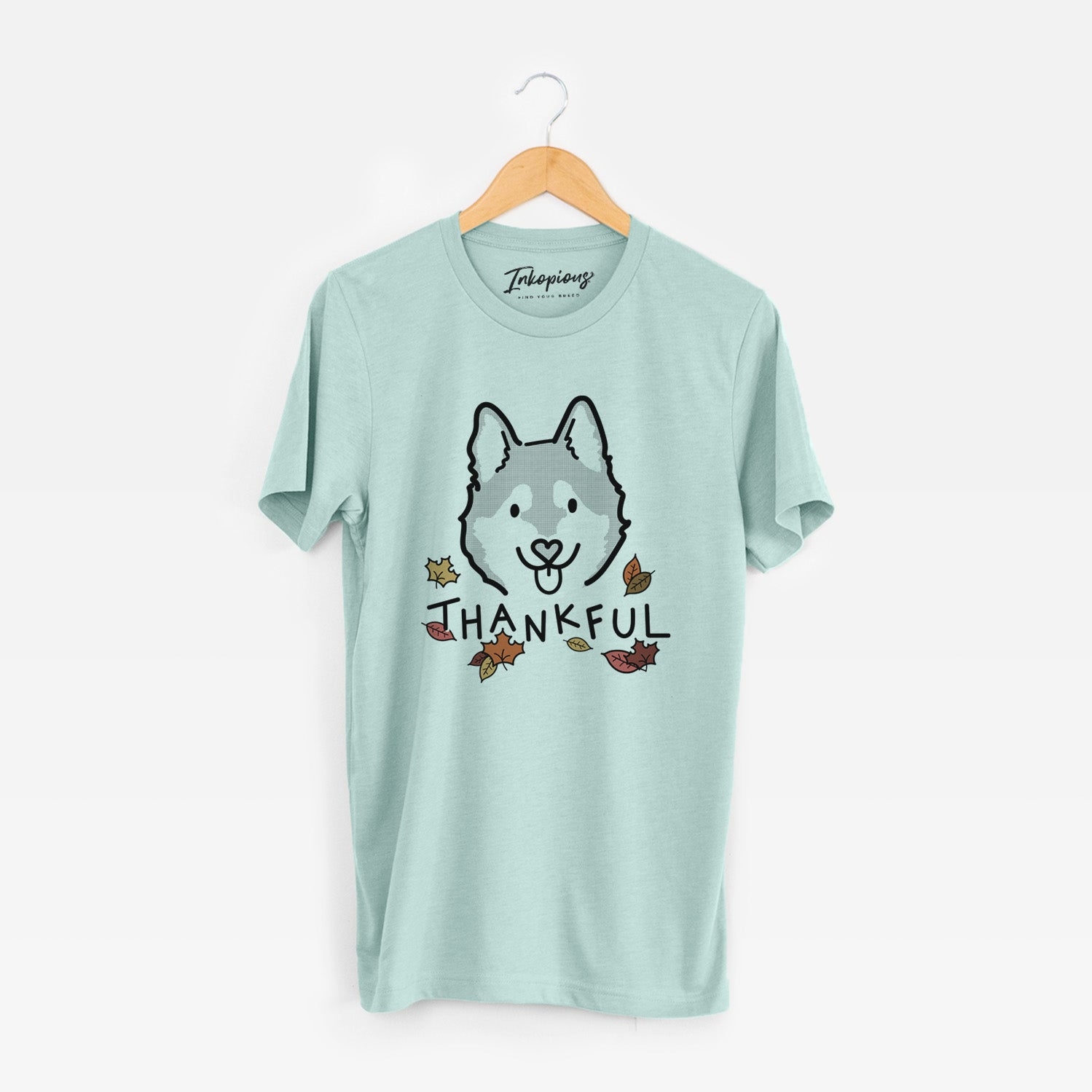 Minimalist line drawing of Sitka the Alaskan Klee Kai with 'Thankful' lettering on a Heather Sage Unisex crewneck