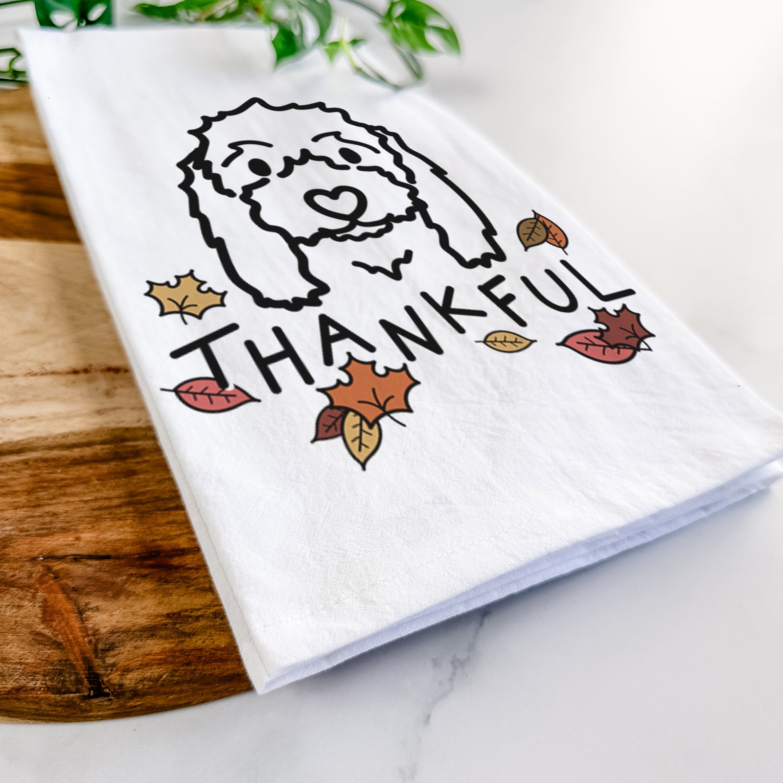 Minimalist line drawing of Sophie the Coton de Tulear with 'Thankful' lettering on a tea towel