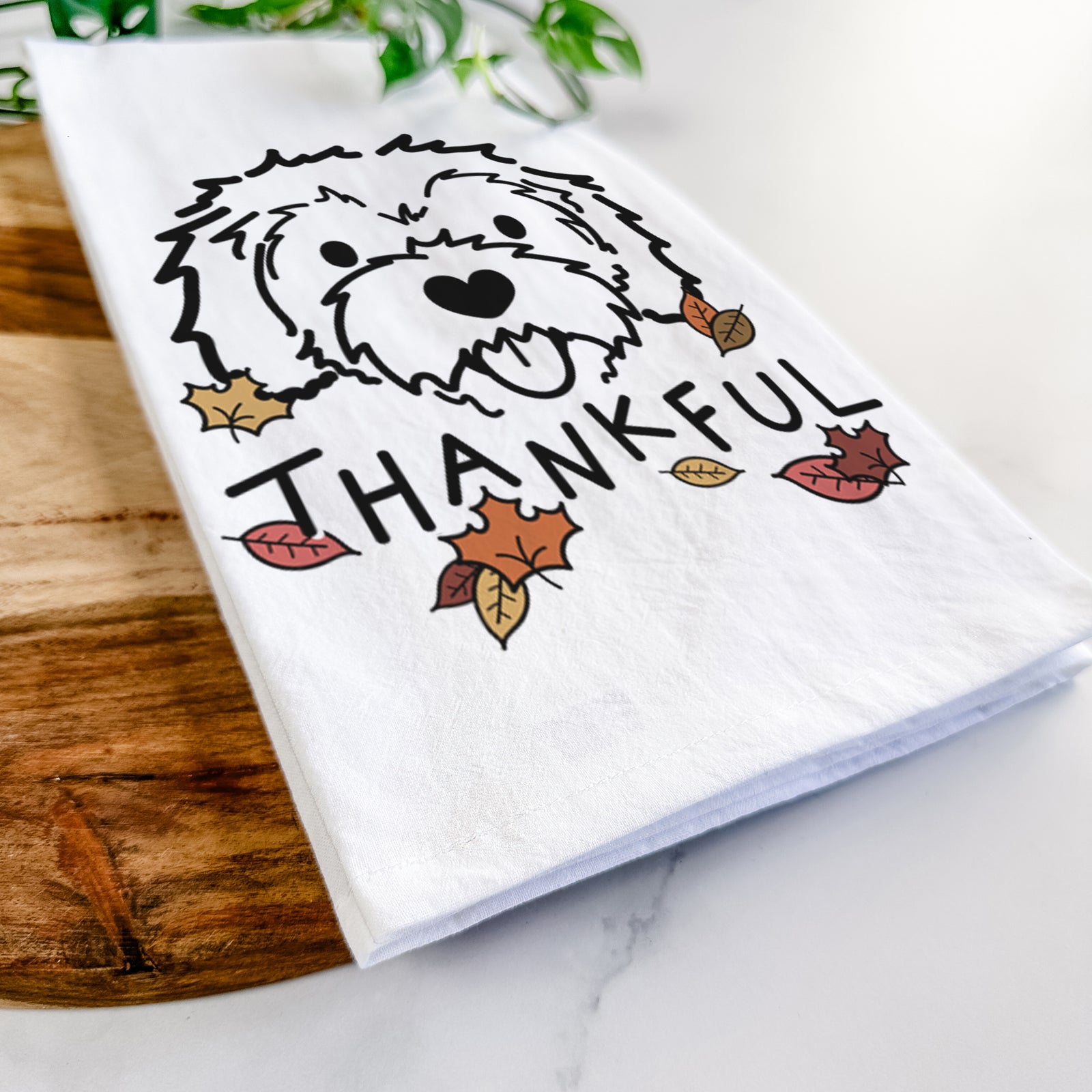Minimalist line drawing of Sprinkles the Cockapoo with 'Thankful' lettering on a tea towel