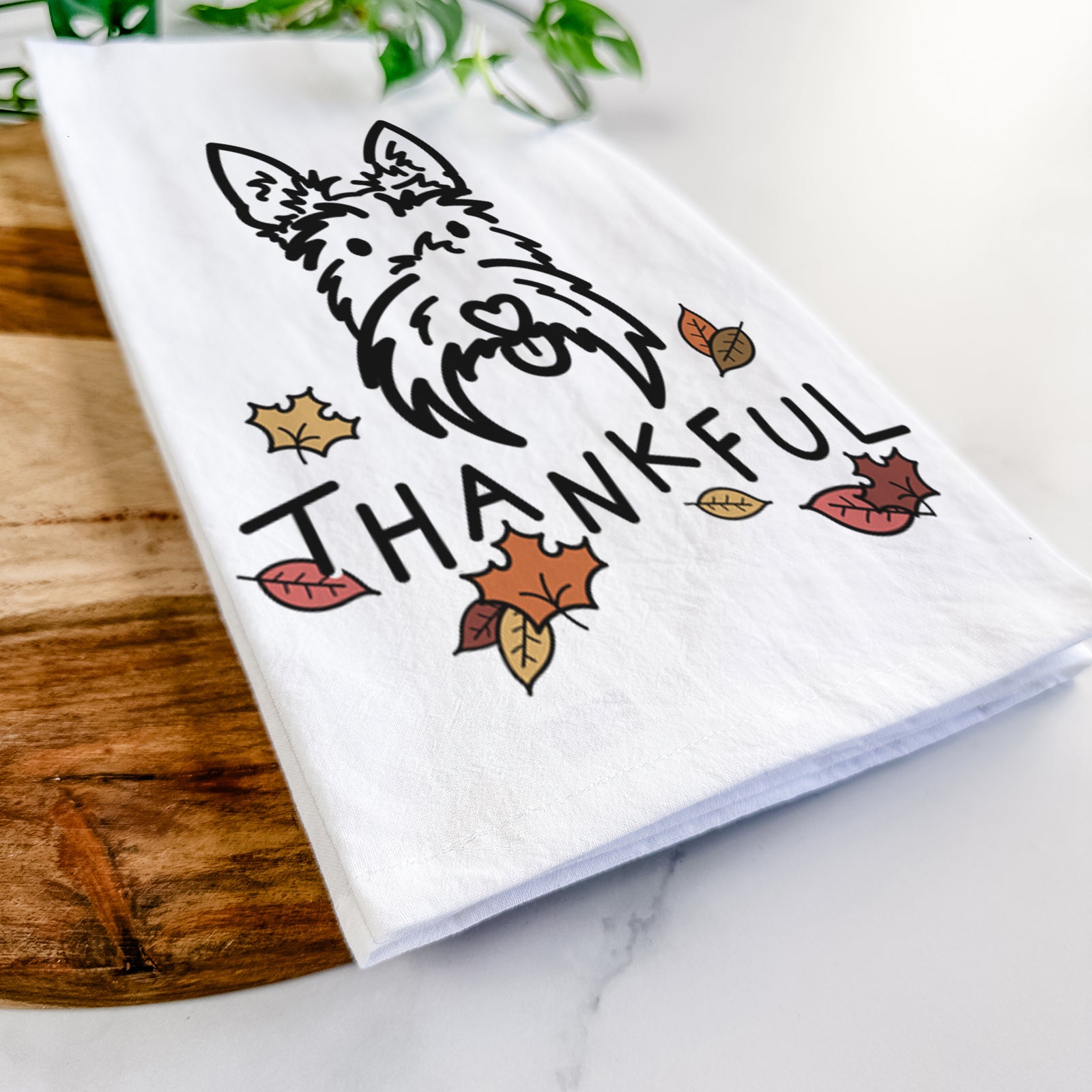 Minimalist line drawing of Thistle the Scottish Terrier with 'Thankful' lettering on a tea towel