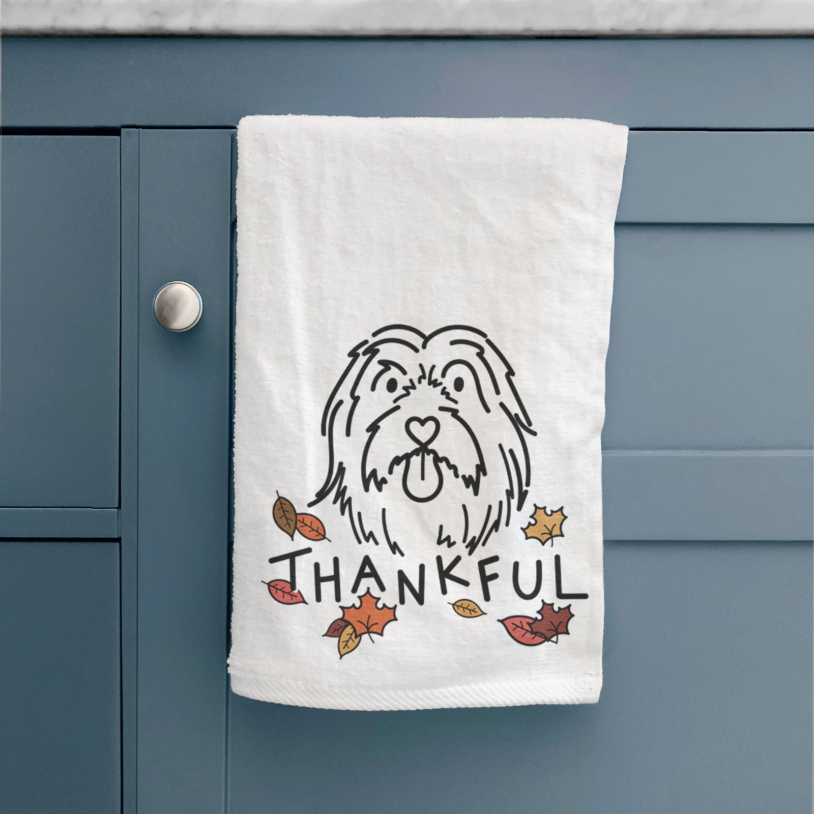 Minimalist line drawing of Tucker the Bearded Collie with 'Thankful' lettering on a decorative hand towel