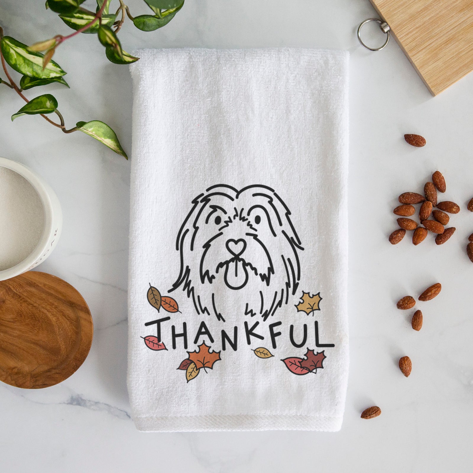 Minimalist line drawing of Tucker the Bearded Collie with 'Thankful' lettering on a decorative hand towel