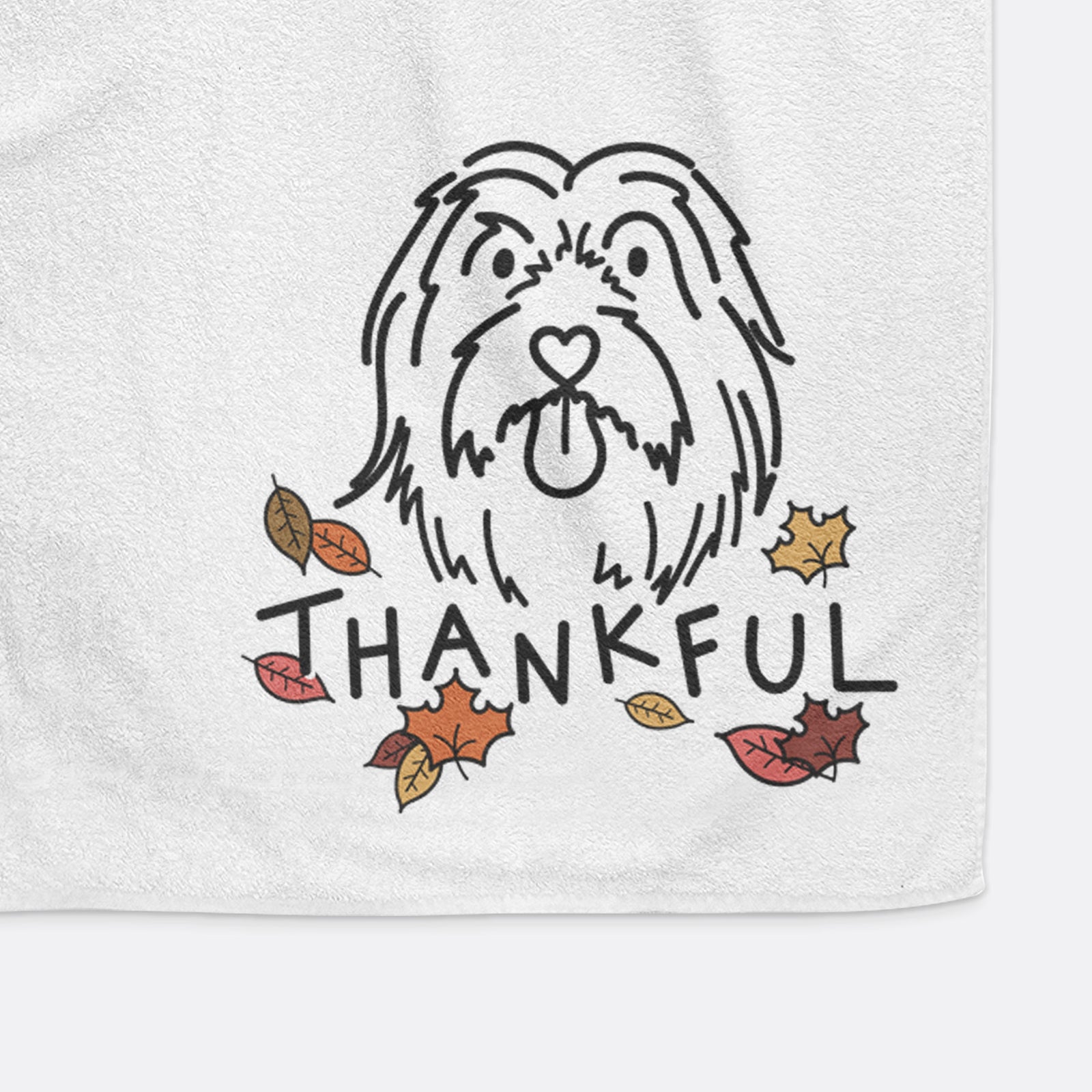 Minimalist line drawing of Tucker the Bearded Collie with 'Thankful' lettering on a decorative hand towel