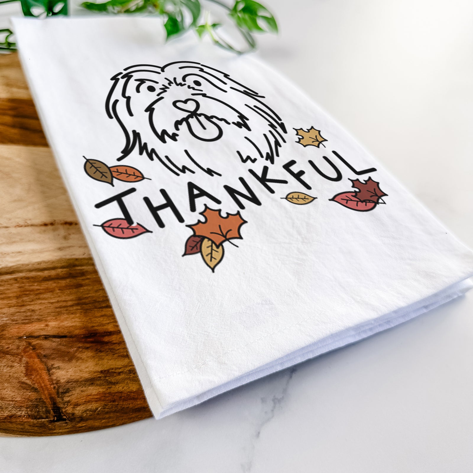 Minimalist line drawing of Tucker the Bearded Collie with 'Thankful' lettering on a tea towel