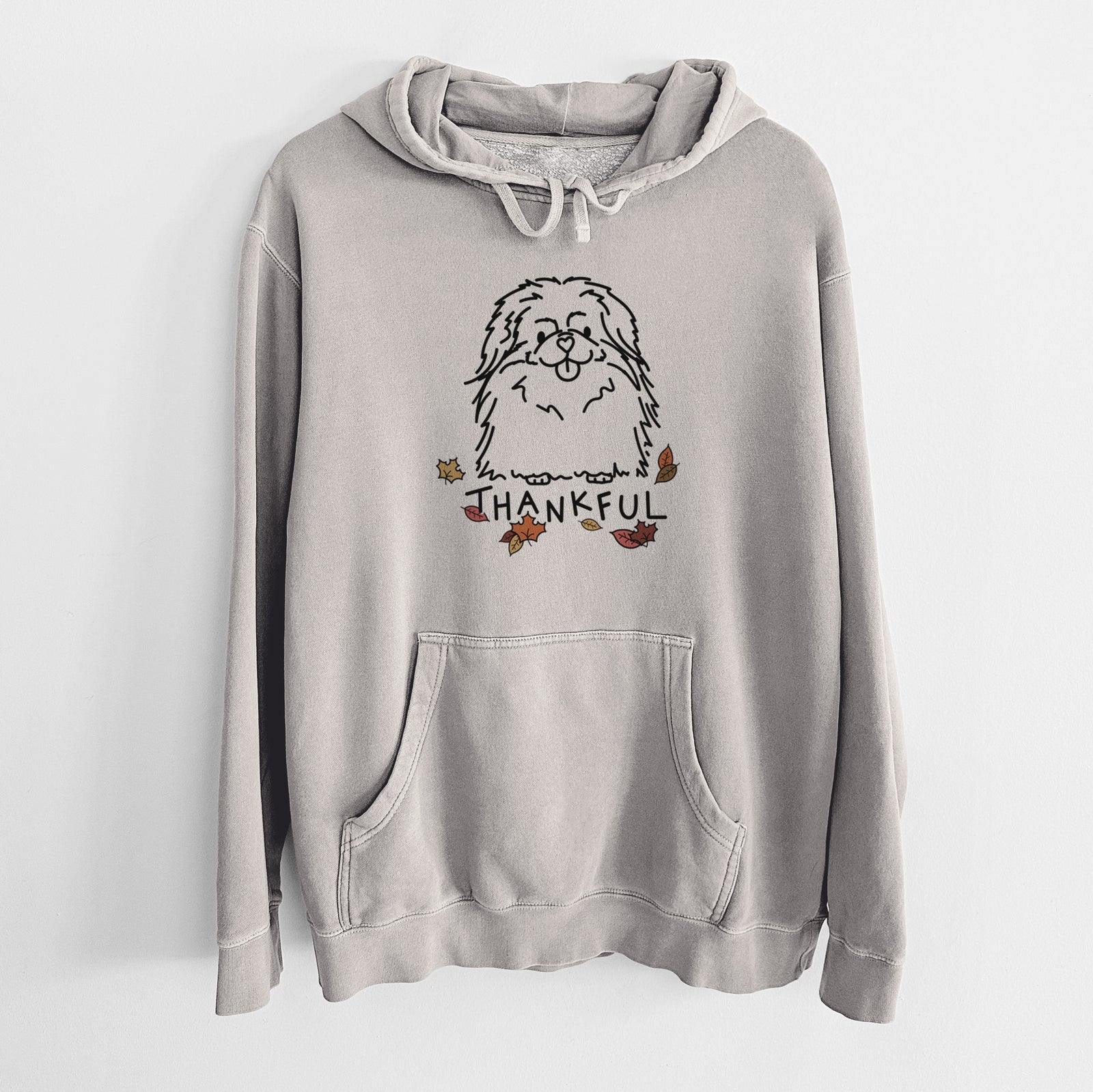 Minimalist line drawing of Viv the Pekingese with 'Thankful' lettering on a Cement Unisex pigment dyed hoodie