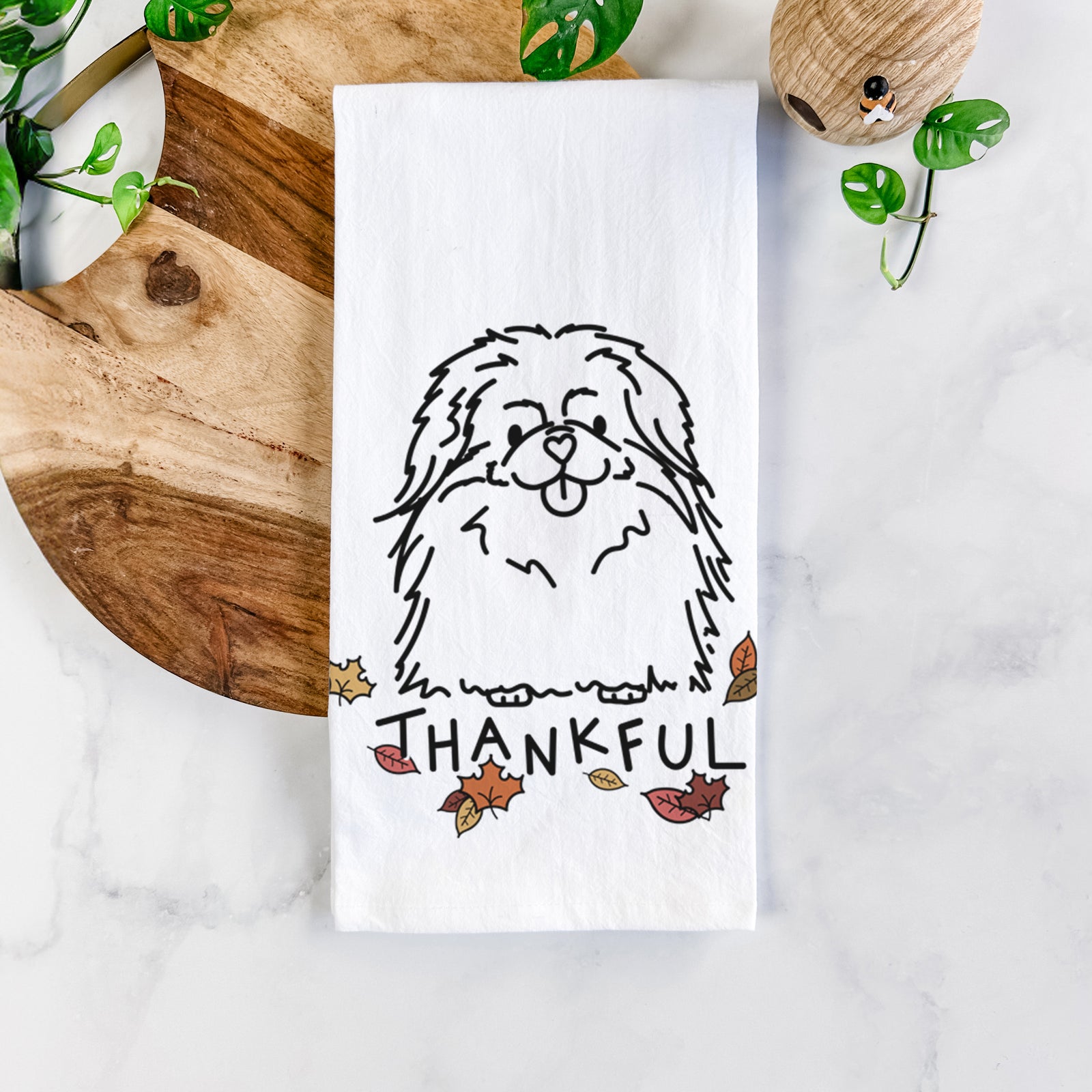Minimalist line drawing of Viv the Pekingese with 'Thankful' lettering on a tea towel