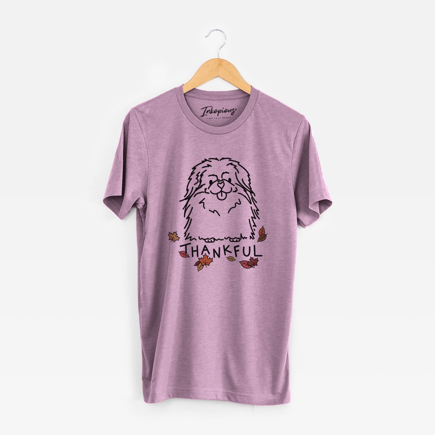 Minimalist line drawing of Viv the Pekingese with 'Thankful' lettering on an Orchid Unisex crewneck