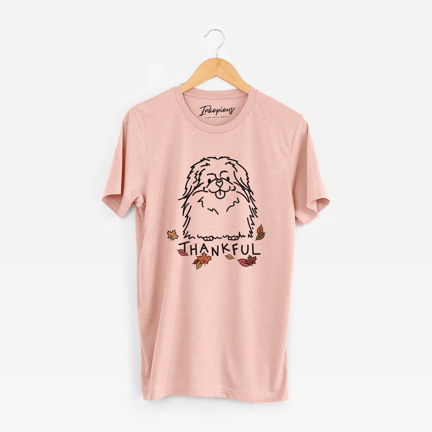Minimalist line drawing of Viv the Pekingese with 'Thankful' lettering on a Peach Unisex crewneck