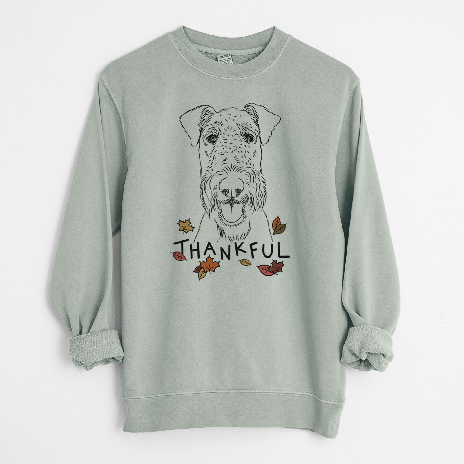 Hand-drawn sketch of Andy the Airedale Terrier with 'Thankful' lettering and autumn leaves on a Sage Unisex pigment dyed crew sweatshirt