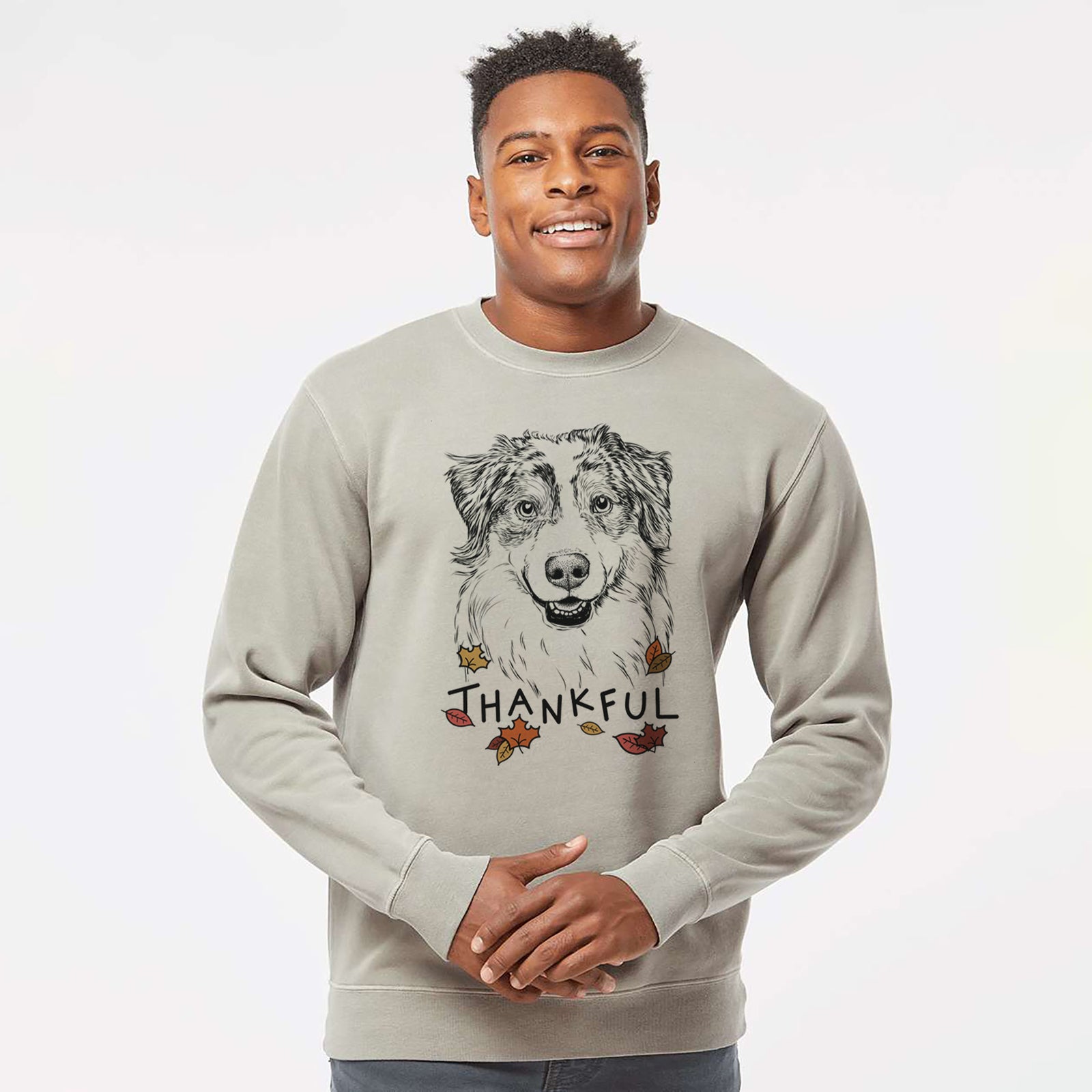 Hand-drawn sketch of Aonghus the Australian Shepherd with 'Thankful' lettering and autumn leaves on a Cement Unisex pigment dyed crew sweatshirt