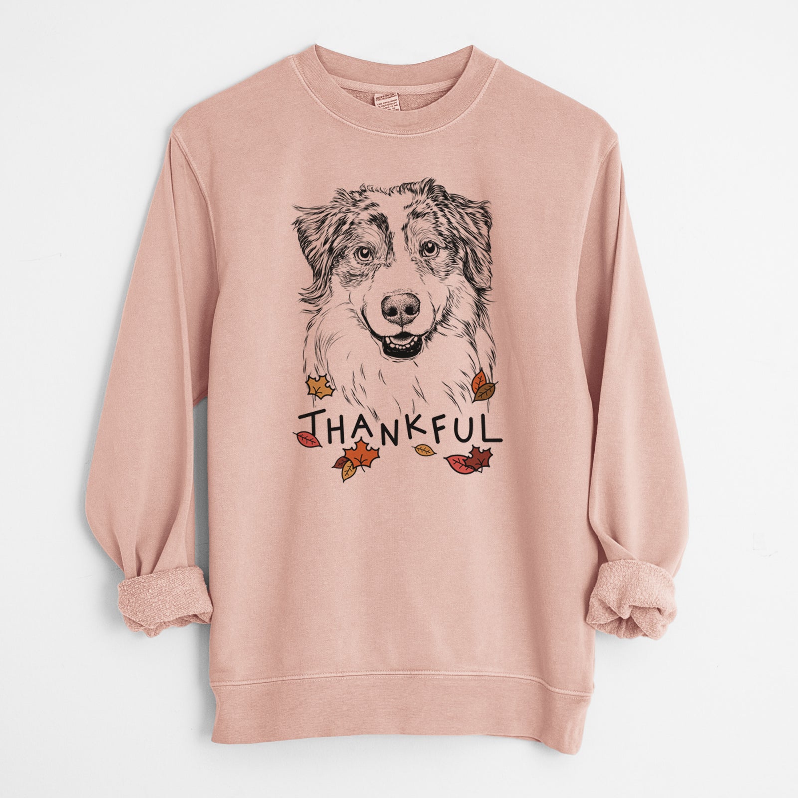 Hand-drawn sketch of Aonghus the Australian Shepherd with 'Thankful' lettering and autumn leaves on a Dusty Pink Unisex pigment dyed crew sweatshirt