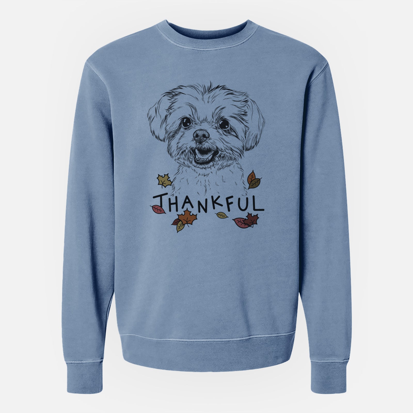 Hand-drawn sketch of Aspen the Morkie with 'Thankful' lettering and autumn leaves on a Slate Blue Unisex pigment dyed crew sweatshirt