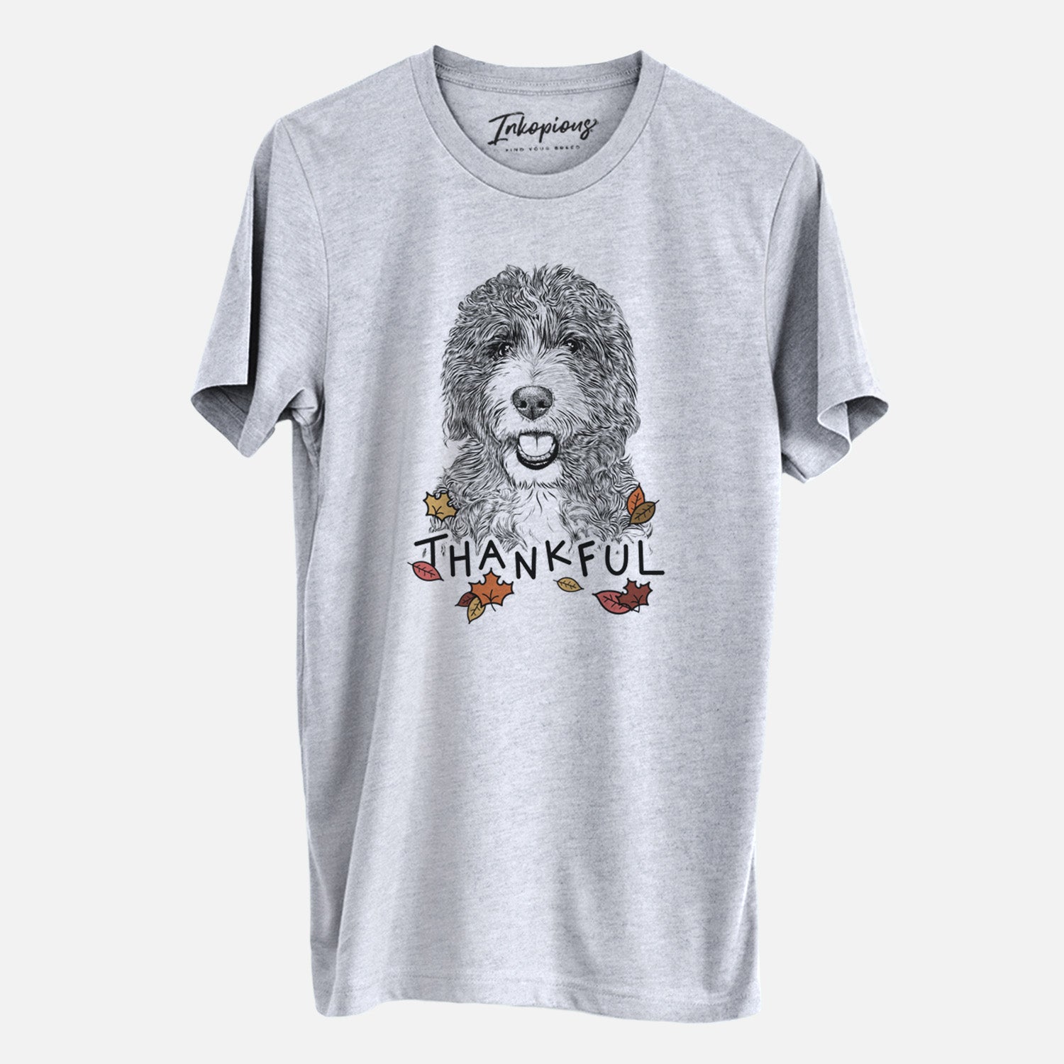 Hand-drawn sketch of Bash the Bernedoodle with 'Thankful' lettering and autumn leaves on a Grey Unisex crewneck