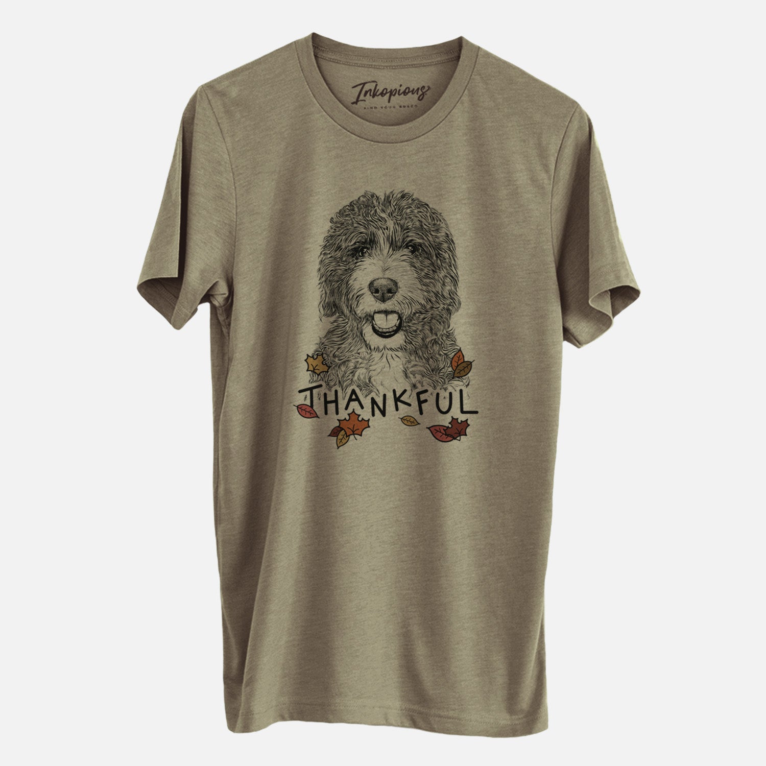 Hand-drawn sketch of Bash the Bernedoodle with 'Thankful' lettering and autumn leaves on an Olive Unisex crewneck