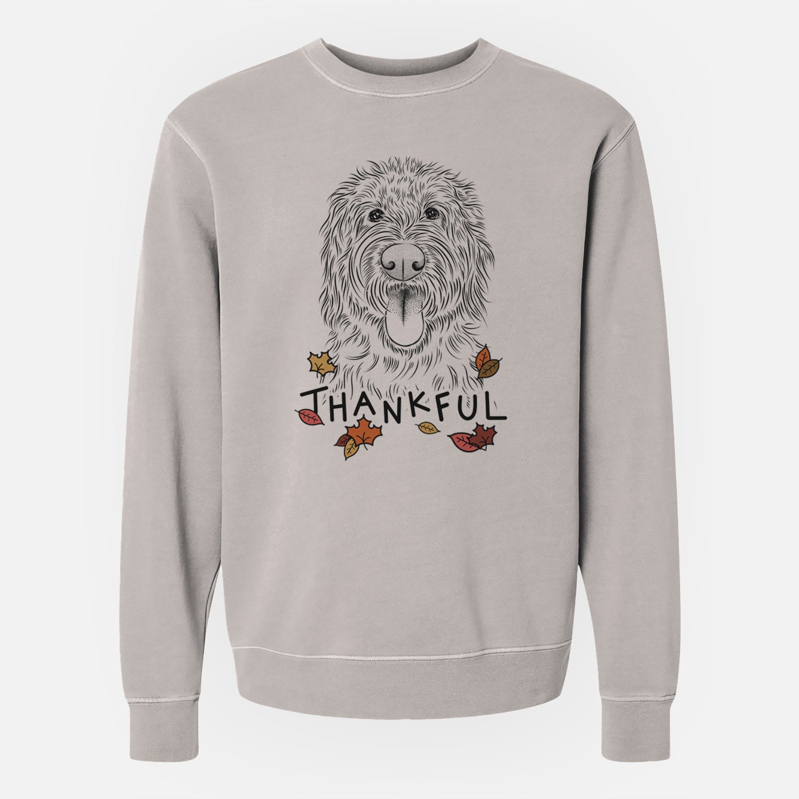 Hand-drawn sketch of Bennett the Doodle with 'Thankful' lettering and autumn leaves on a Cement Unisex pigment dyed crew sweatshirt