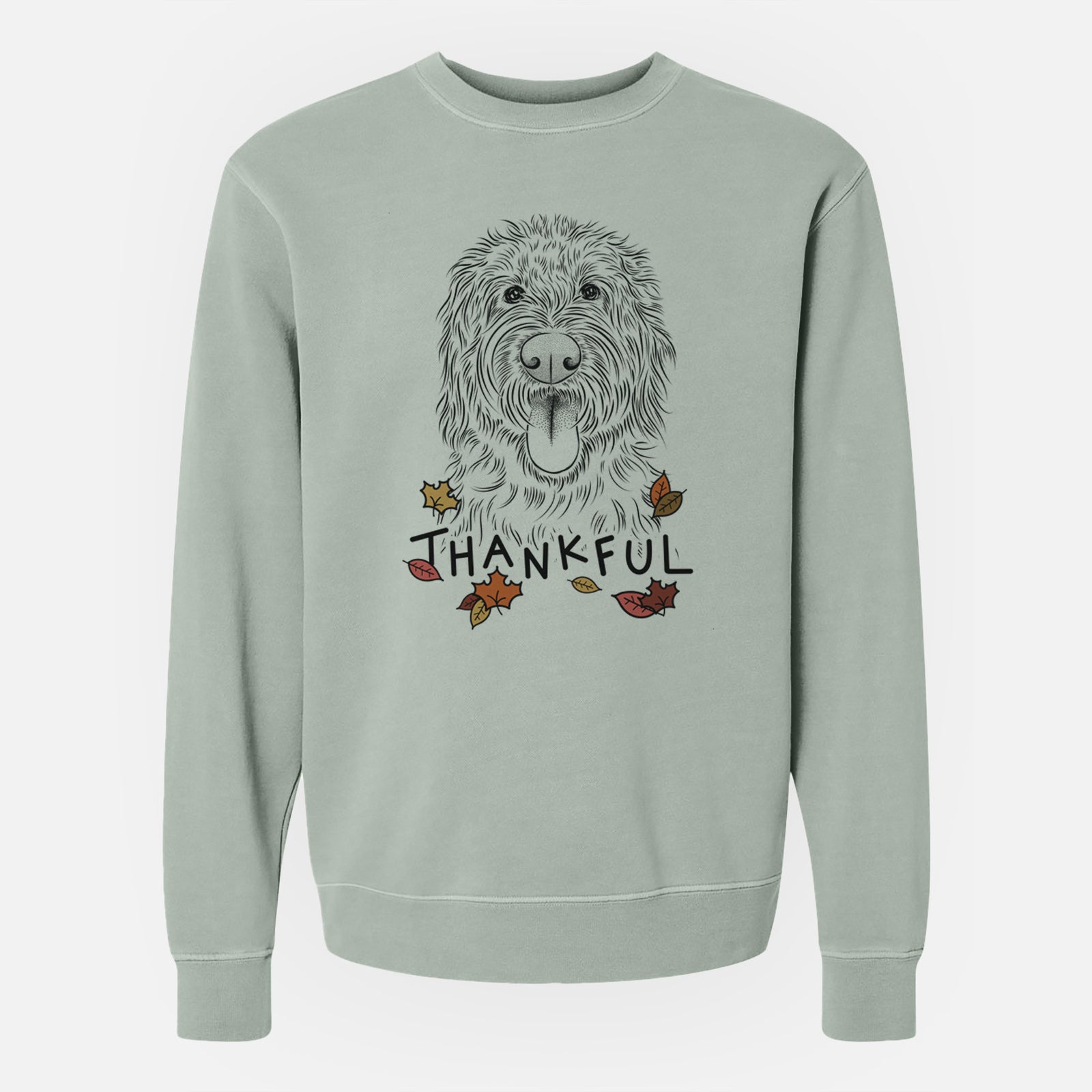 Hand-drawn sketch of Bennett the Doodle with 'Thankful' lettering and autumn leaves on a Sage Unisex pigment dyed crew sweatshirt