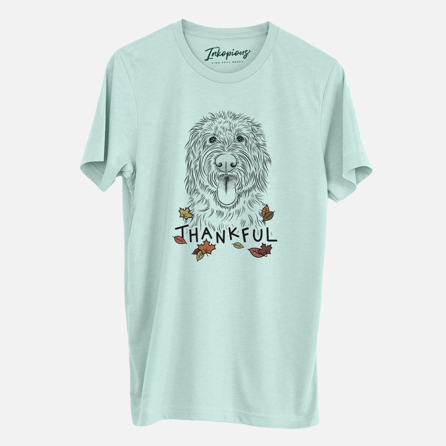 Hand-drawn sketch of Bennett the Doodle with 'Thankful' lettering and autumn leaves on a Heather Sage Unisex crewneck