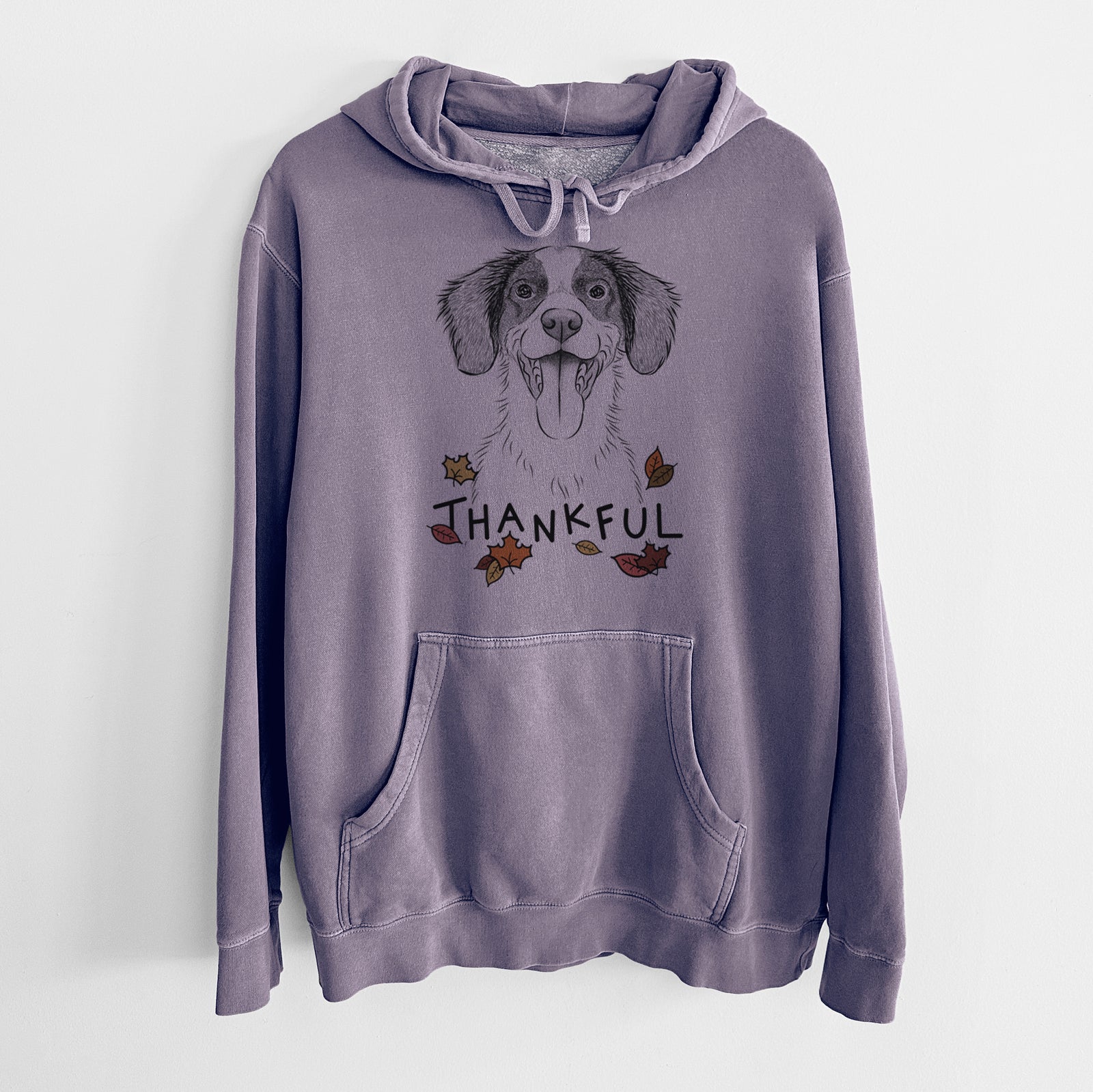 Hand-drawn sketch of Birdie the Brittany with 'Thankful' lettering and autumn leaves on a Plum Unisex pigment dyed hoodie