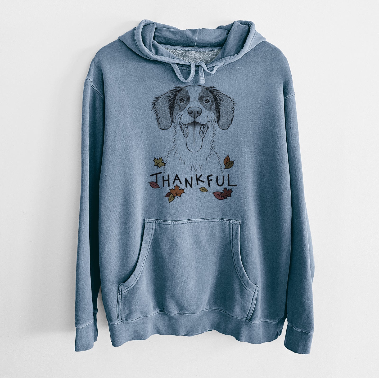 Hand-drawn sketch of Birdie the Brittany with 'Thankful' lettering and autumn leaves on a Slate Blue Unisex pigment dyed hoodie