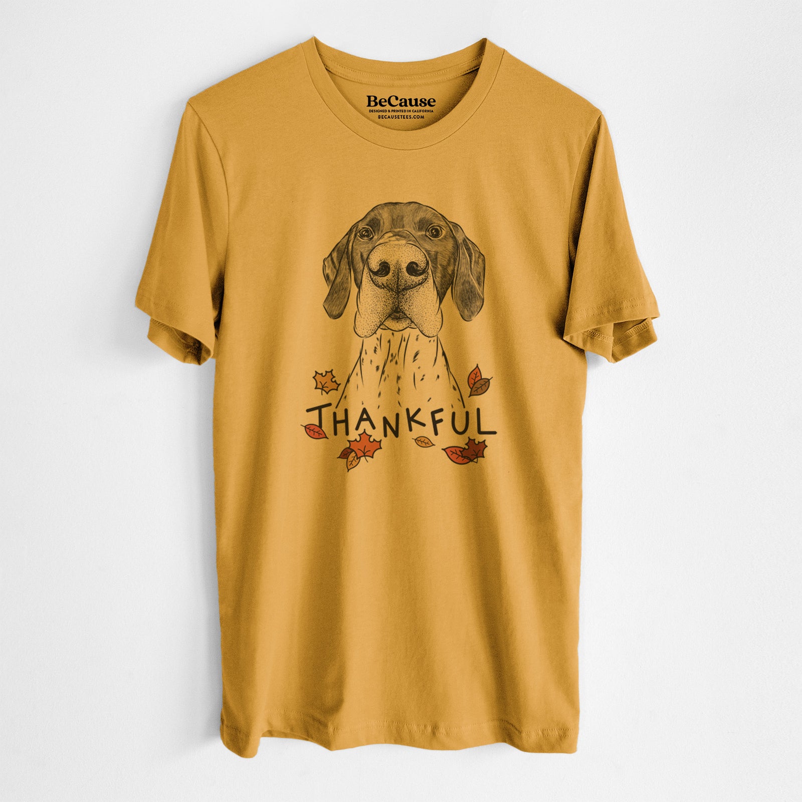 Hand-drawn sketch of Booze the German Shorthaired Pointer with 'Thankful' lettering and autumn leaves on a Mustard Unisex crewneck, worn by a man