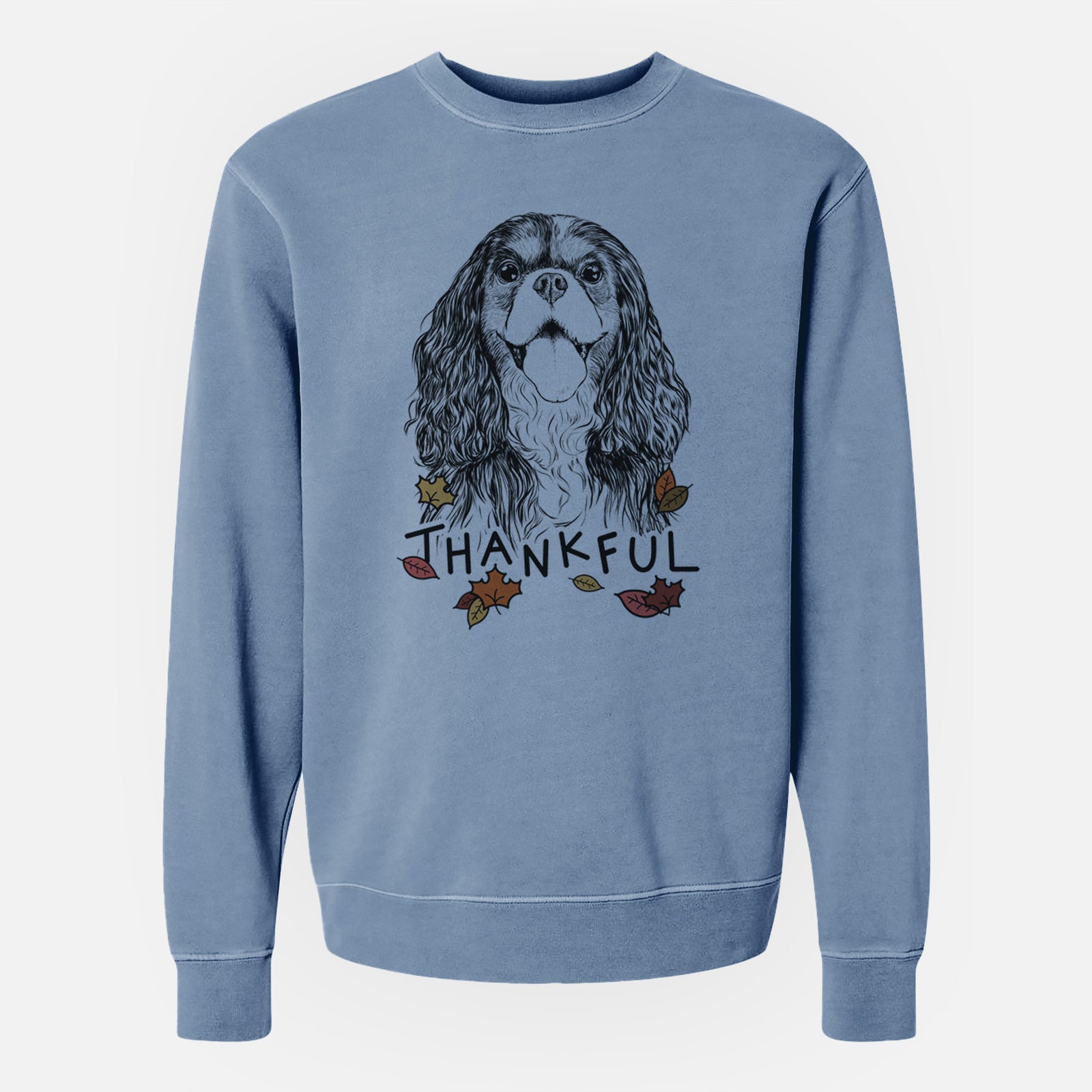 Hand-drawn sketch of Brandy the Cavalier King Charles Spaniel with 'Thankful' lettering and autumn leaves on a Slate Blue Unisex pigment dyed crew sweatshirt