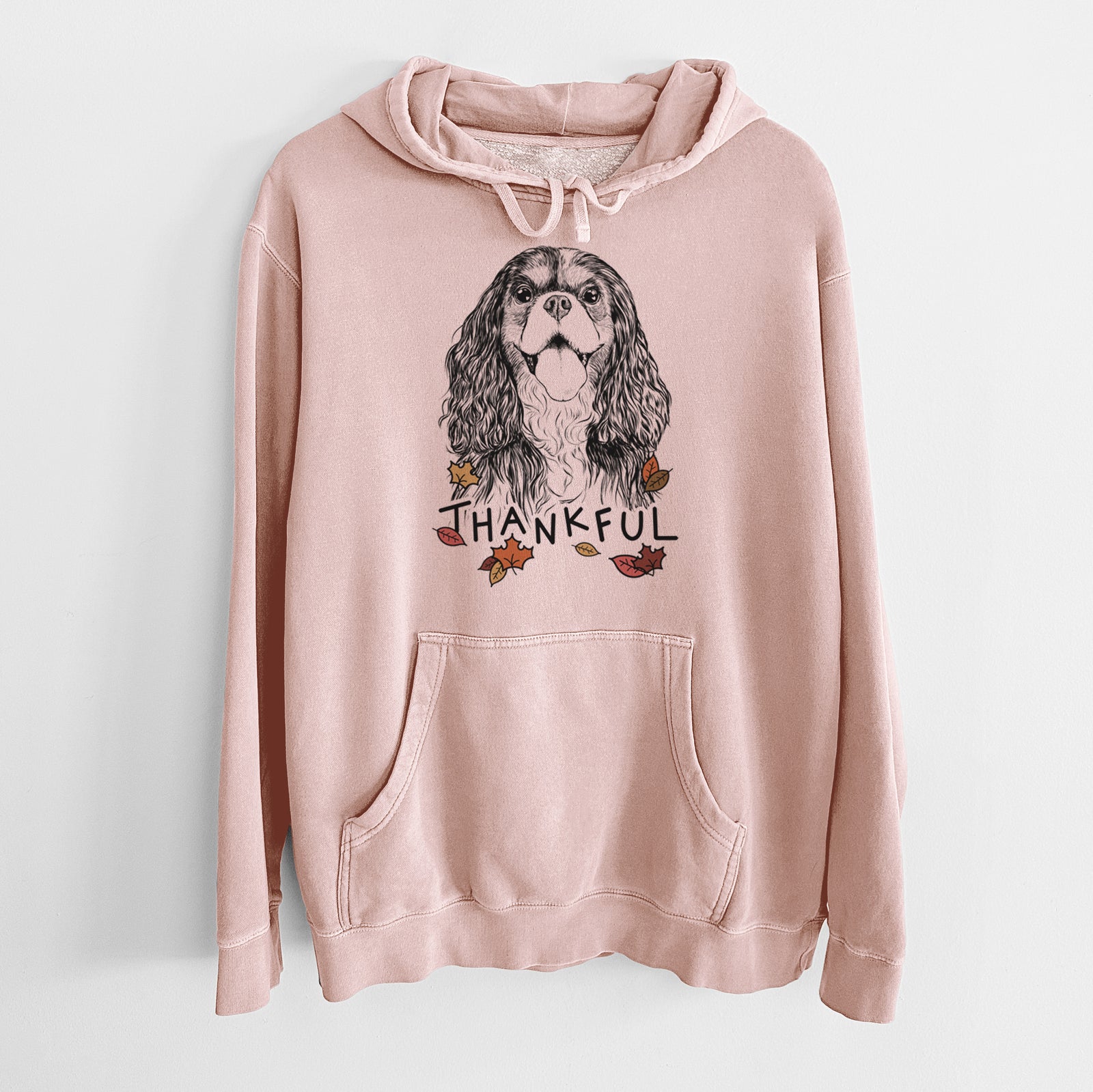 Hand-drawn sketch of Brandy the Cavalier King Charles Spaniel with 'Thankful' lettering and autumn leaves on a Dusty Pink Unisex pigment dyed hoodie