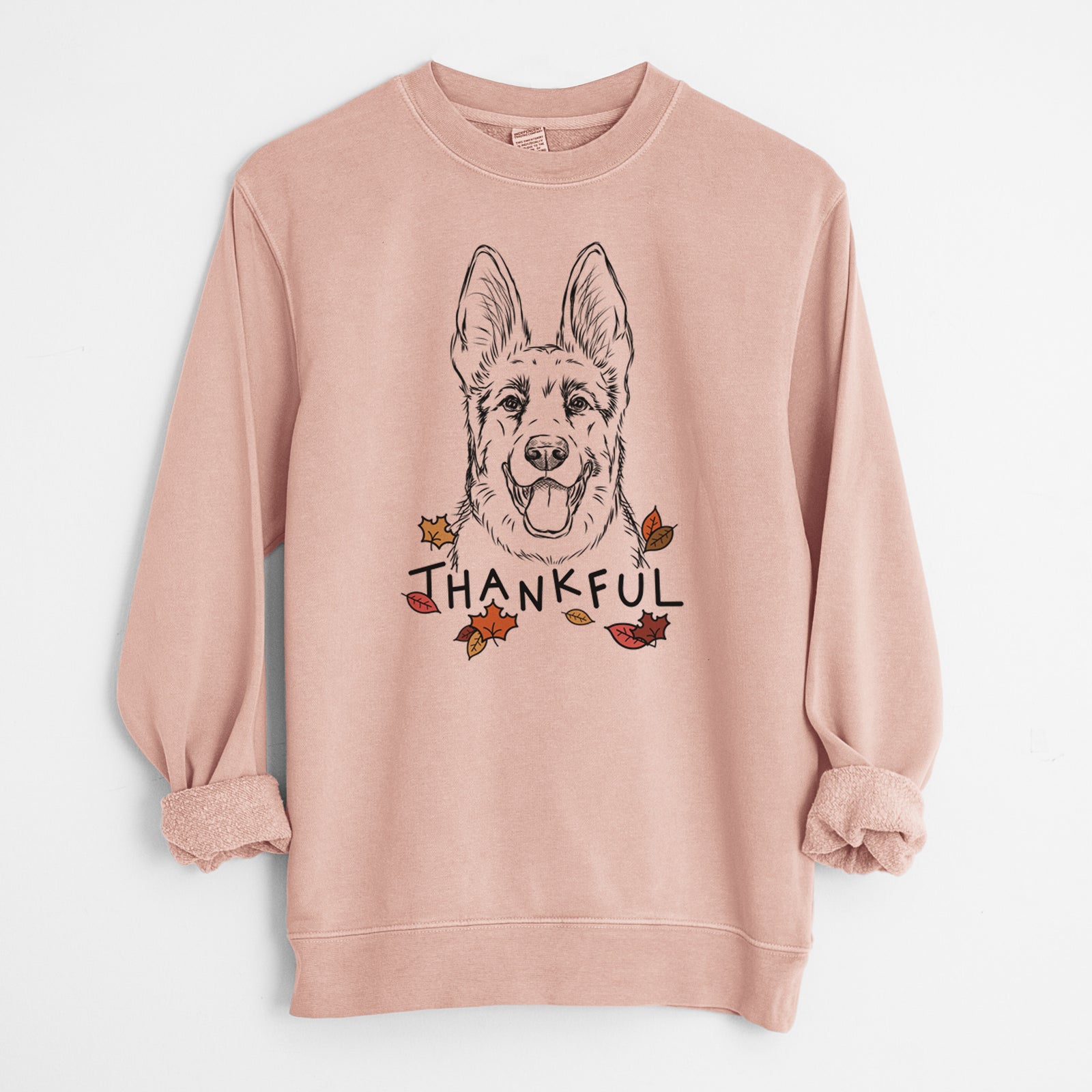 Hand-drawn sketch of Brutus the German Shepherd with 'Thankful' lettering and autumn leaves on a Dusty Pink Unisex pigment dyed crew sweatshirt