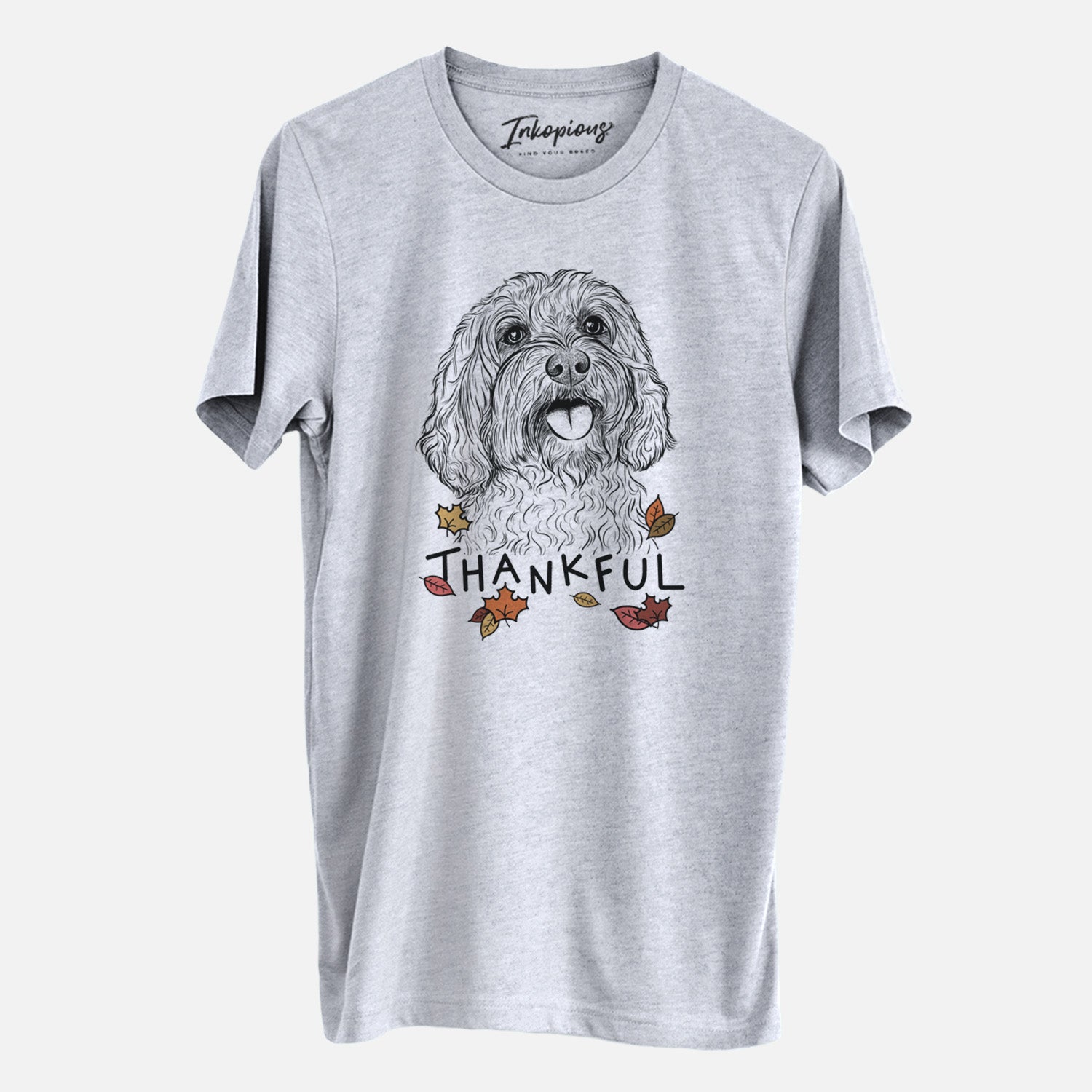 Hand-drawn sketch of Cali the Cavapoo with 'Thankful' lettering and autumn leaves on a Grey Unisex crewneck