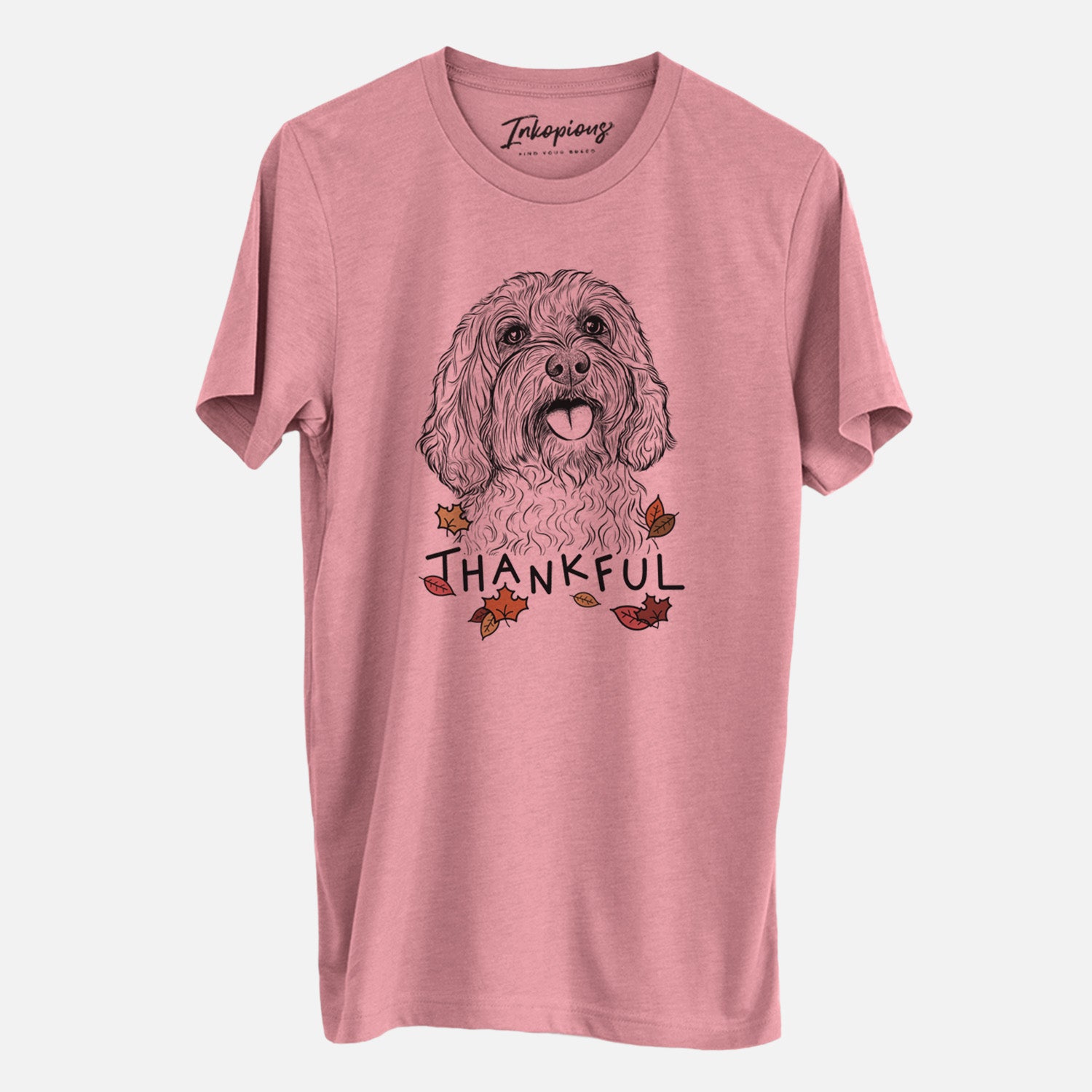 Hand-drawn sketch of Cali the Cavapoo with 'Thankful' lettering and autumn leaves on a Mauve Unisex crewneck