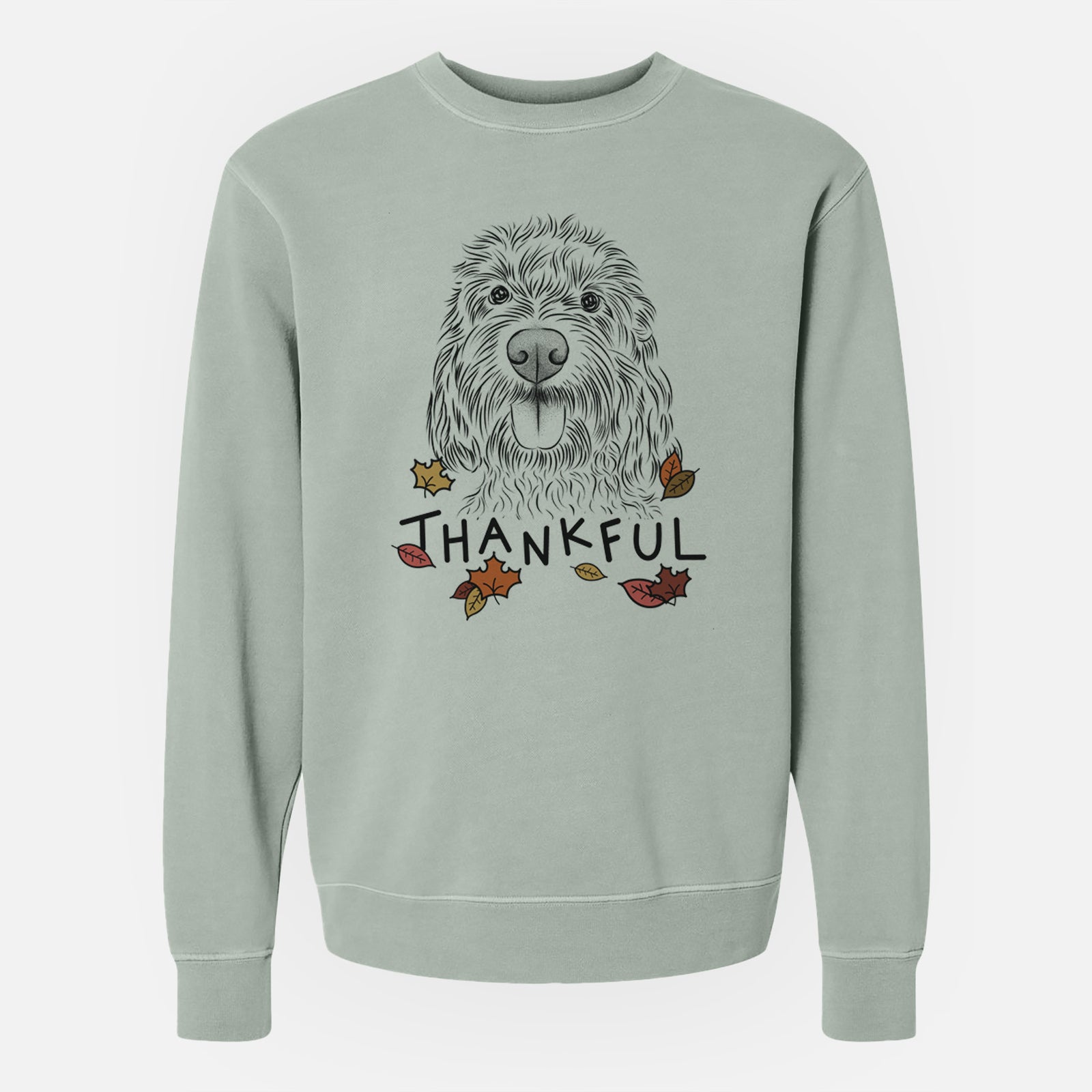 Hand-drawn sketch of Clover the Cockapoo with 'Thankful' lettering and autumn leaves on a Sage Unisex pigment dyed crew sweatshirt