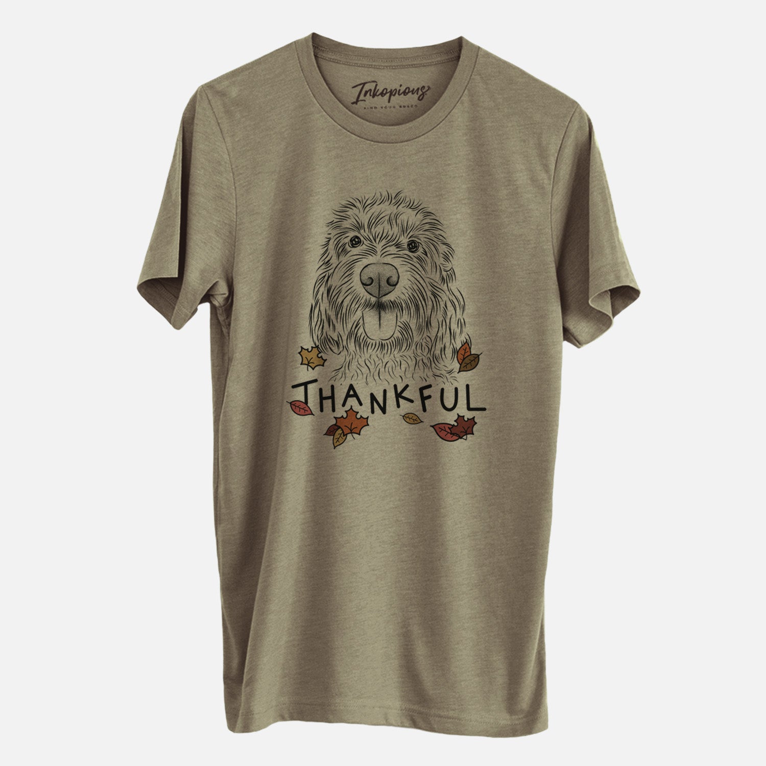 Hand-drawn sketch of Clover the Cockapoo with 'Thankful' lettering and autumn leaves on an Olive Unisex crewneck