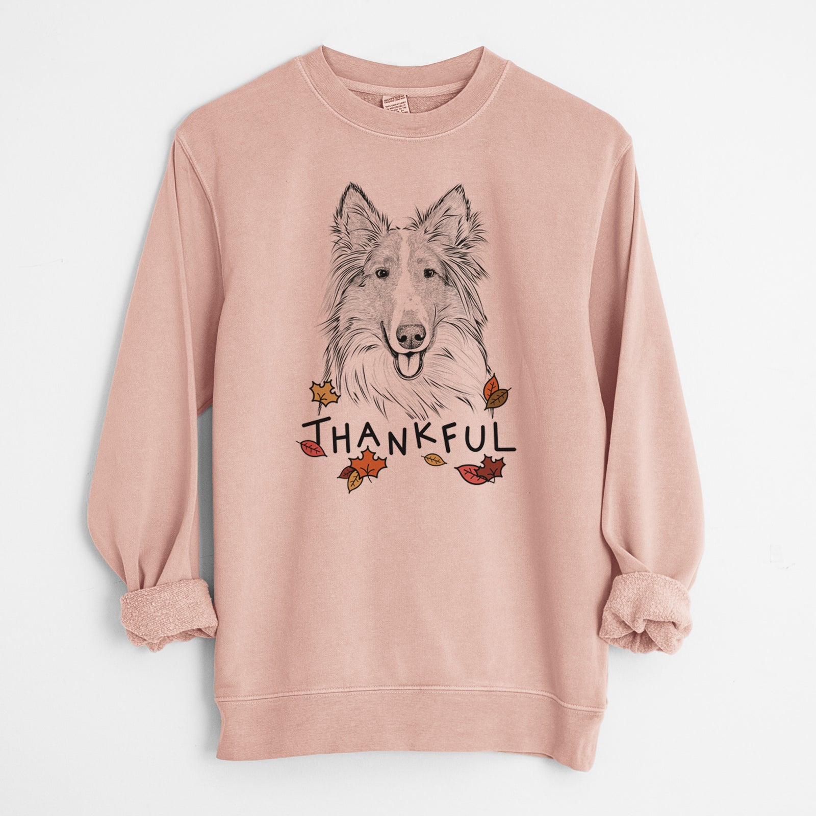 Hand-drawn sketch of Conrad the Rough Collie with 'Thankful' lettering and autumn leaves on a Dusty Pink Unisex pigment dyed crew sweatshirt