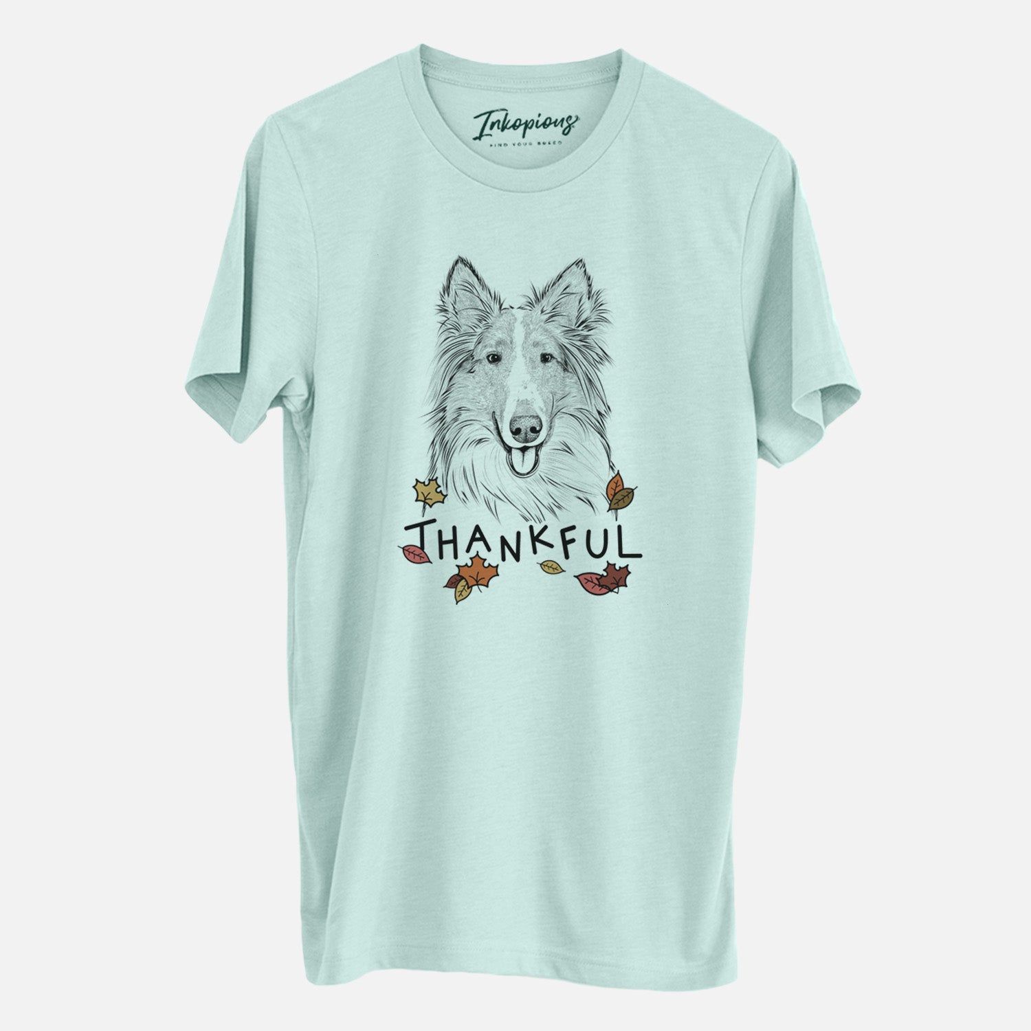 Hand-drawn sketch of Conrad the Rough Collie with 'Thankful' lettering and autumn leaves on a Heather Sage Unisex crewneck