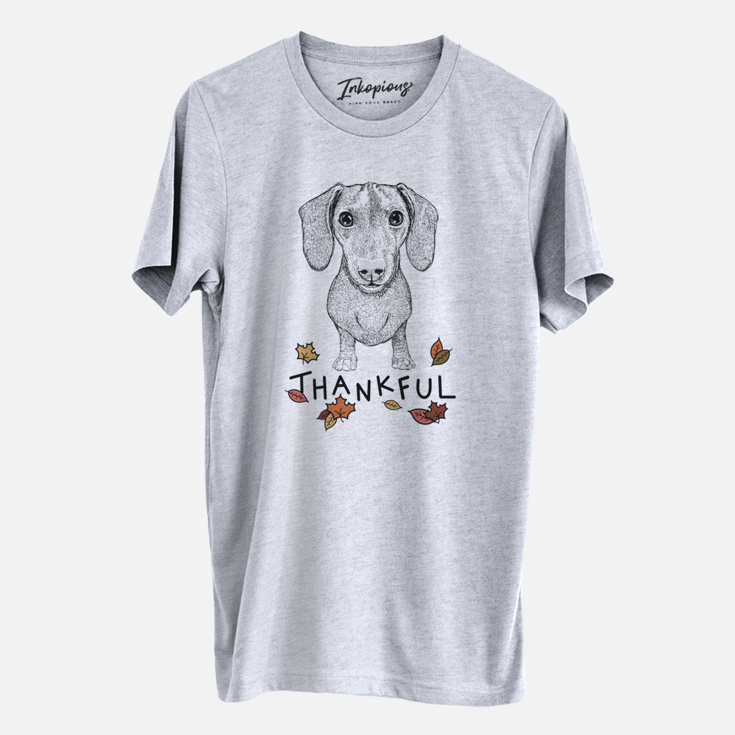 Hand-drawn sketch of Ernie the Mini Dachshund with 'Thankful' lettering and autumn leaves on a Grey Unisex crewneck