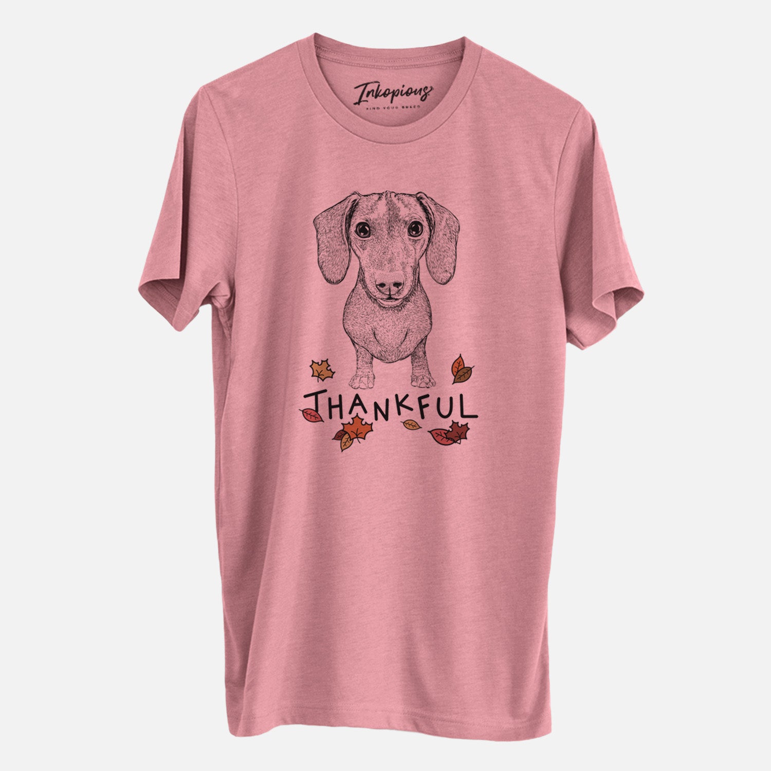 Hand-drawn sketch of Ernie the Mini Dachshund with 'Thankful' lettering and autumn leaves on a Mauve Unisex crewneck