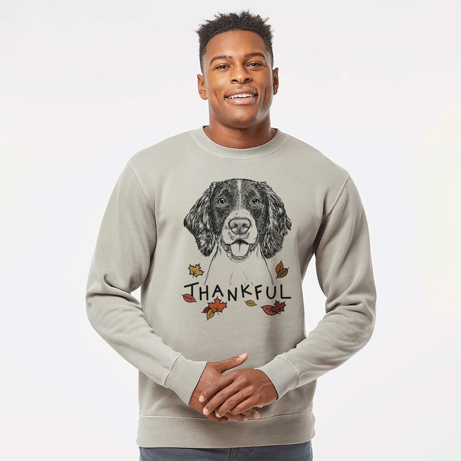 Hand-drawn sketch of Ever the English Springer Spaniel with 'Thankful' lettering and autumn leaves on a Cement Unisex pigment dyed crew sweatshirt