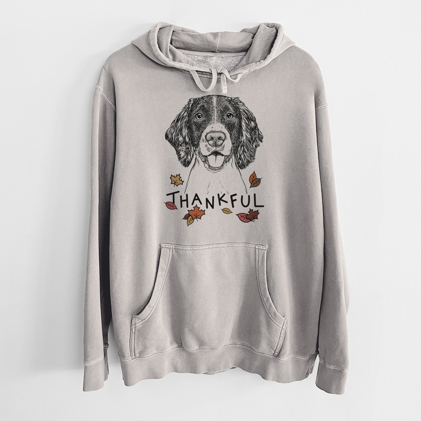 Hand-drawn sketch of Ever the English Springer Spaniel with 'Thankful' lettering and autumn leaves on a Cement Unisex pigment dyed hoodie
